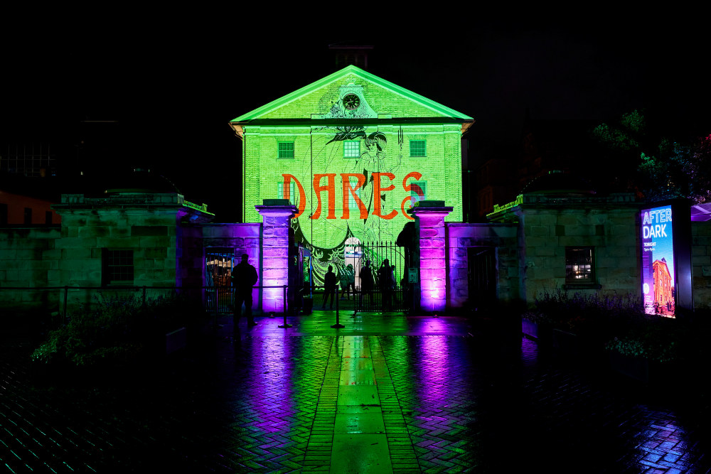 The facade of the Hyde Park Barracks featuring 'Love that dares', a projected artwork by Jacqui North.
