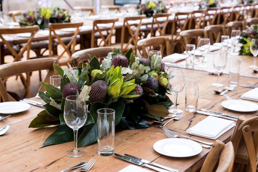 Close up of table setting and flower arrangement at an event marquee in the Hyde Park Barracks Courtyard