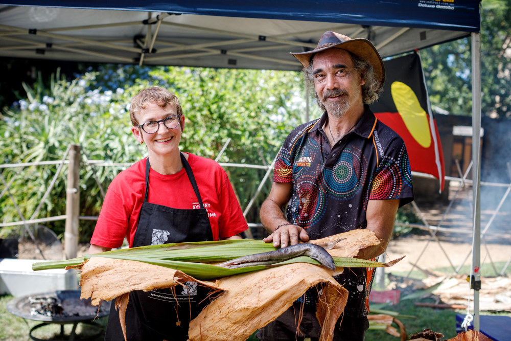 SLM's gastronomer, Jacqui Newling, holding an eel with Fred, the Bush Tucker Man