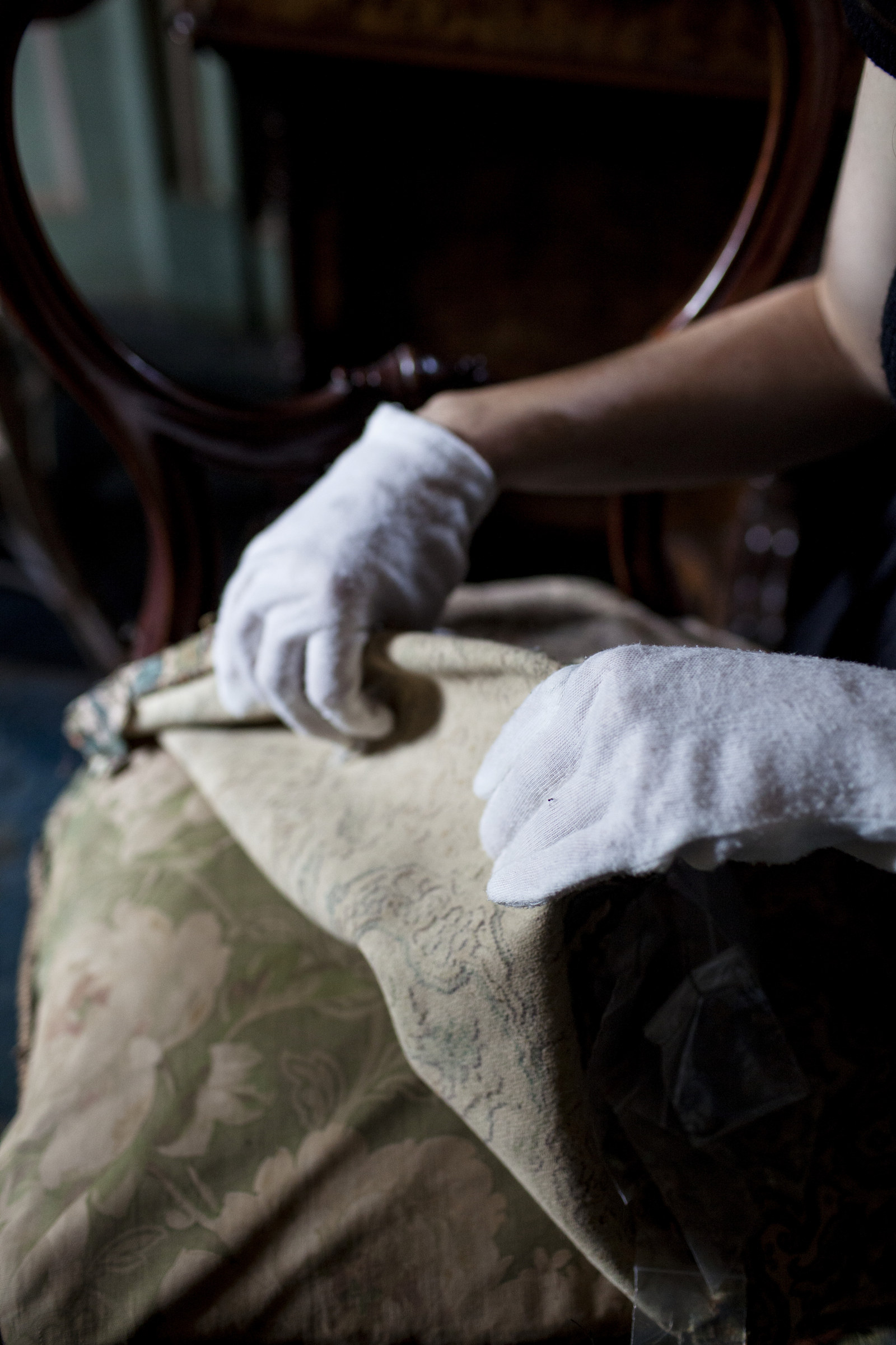  Investigating layers of upholstery on balloon-back chair, Rouse Hill House and Farm   