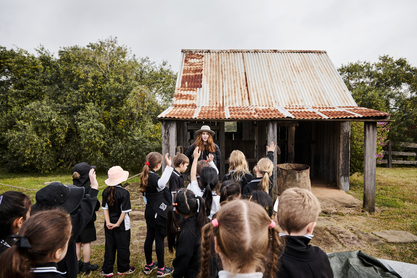 A group of students and Sydney Living Museums curriculum program deliverer Hannah at the Old Dairy as part of the Early to Rise program at Rouse Hill Estate