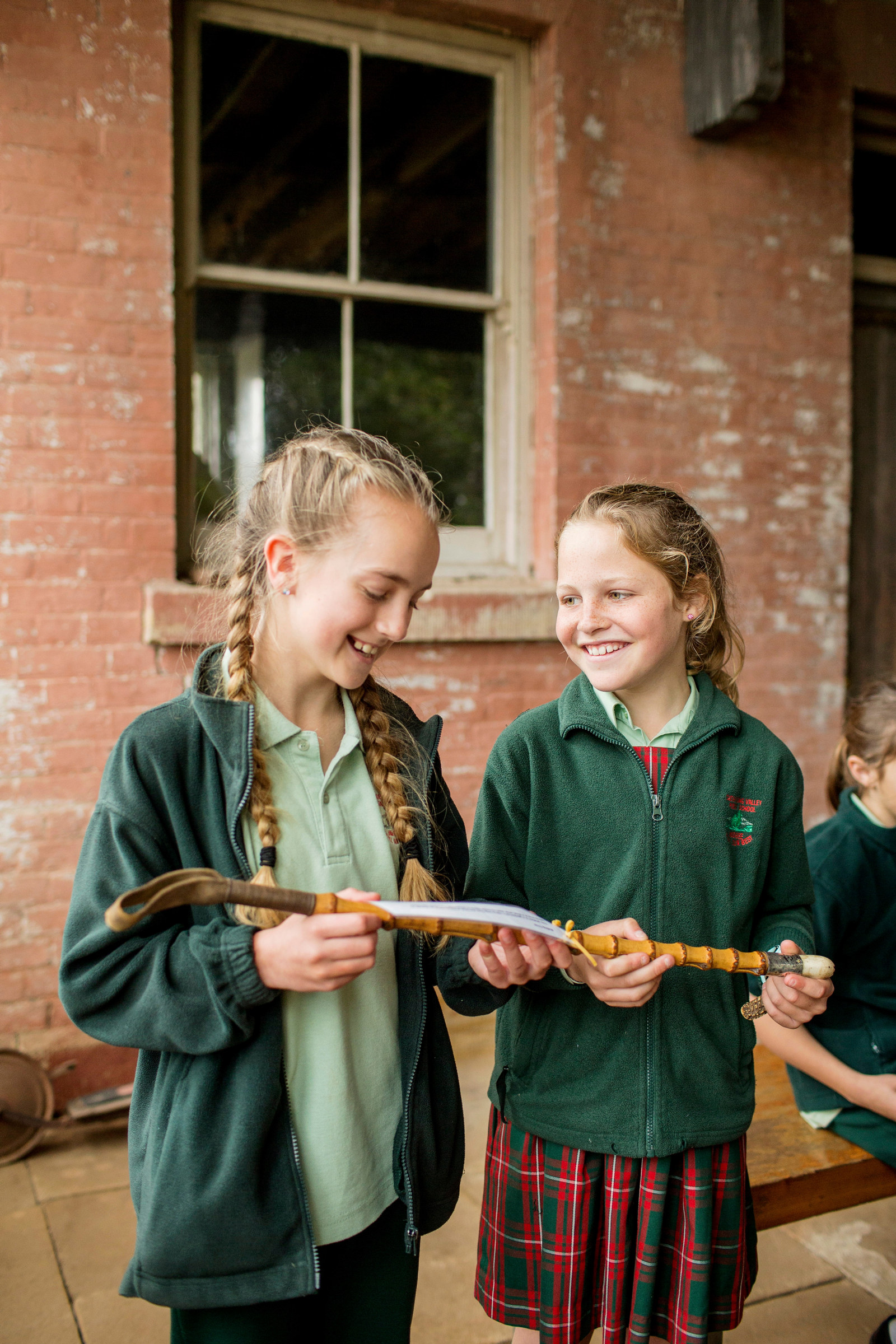Students examining a riding crop in the Arcade at the rear of Rouse Hill House during the program Expanding the Colony at Rouse Hill Estate