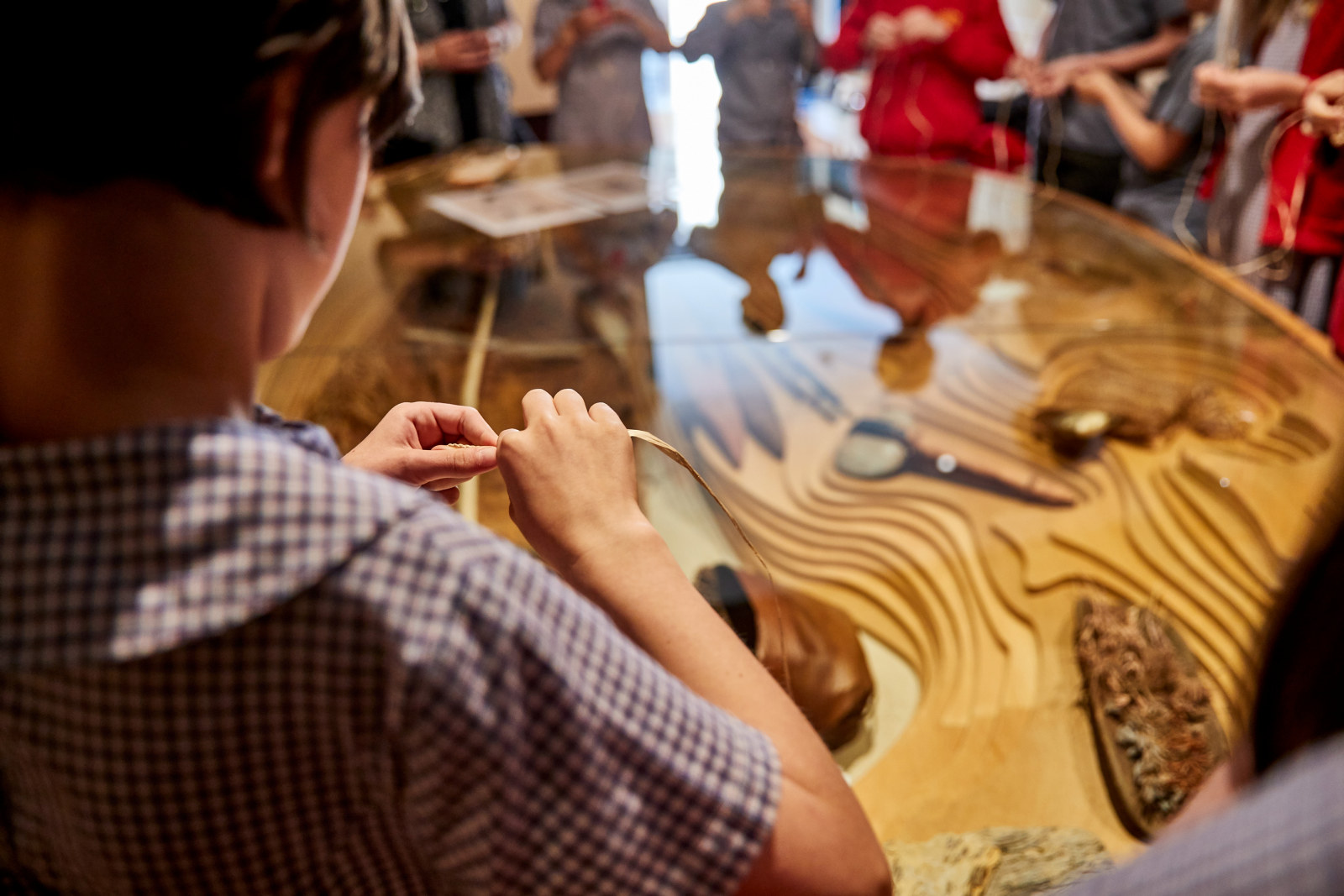 Students learning an Aboriginal stringing technique in the Gadigal Place Gallery of the Museum of Sydney as part of the Garuwanga Gurad (Stories that belong to Country) program