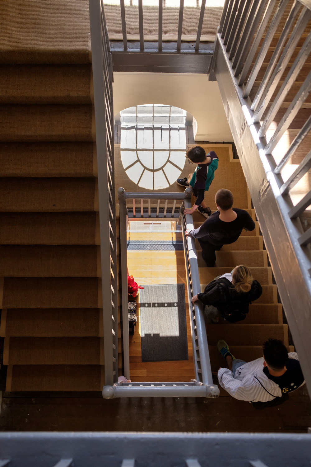 Overhead view of students walking down stairs in the Barracks.