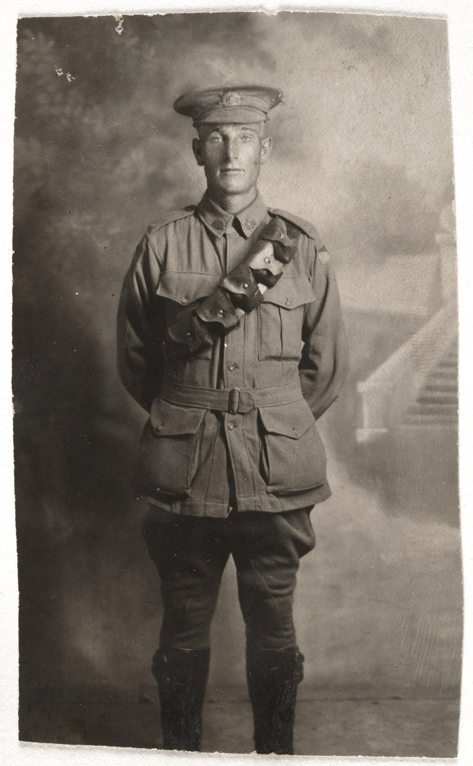 Black and white postcard of young man in uniform