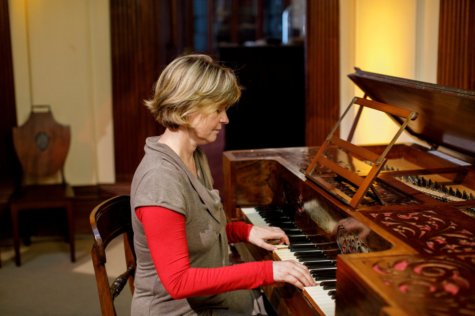 Sandra France, pianist and composer, playing piano in the saloon at Elizabeth Bay House