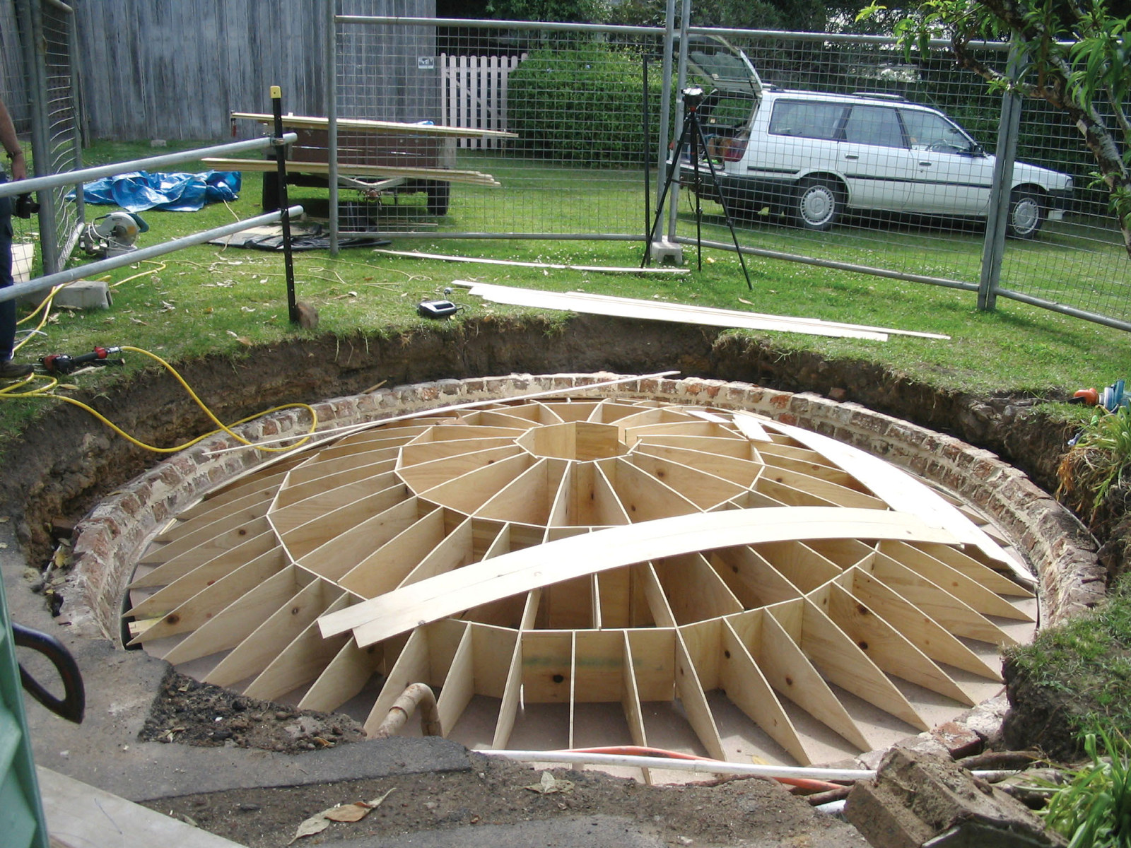 Underground brick water tank or cistern with domed roof being demolished and reconstructed.