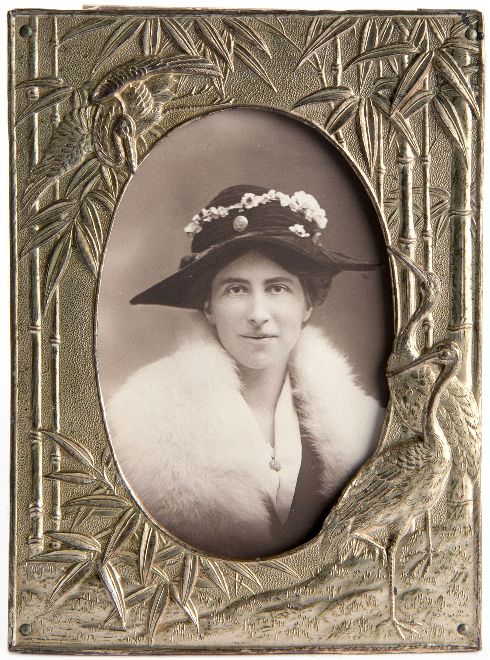 Framed platinum silver gelatin print of a woman wearing a hat trimmed with flowers.
