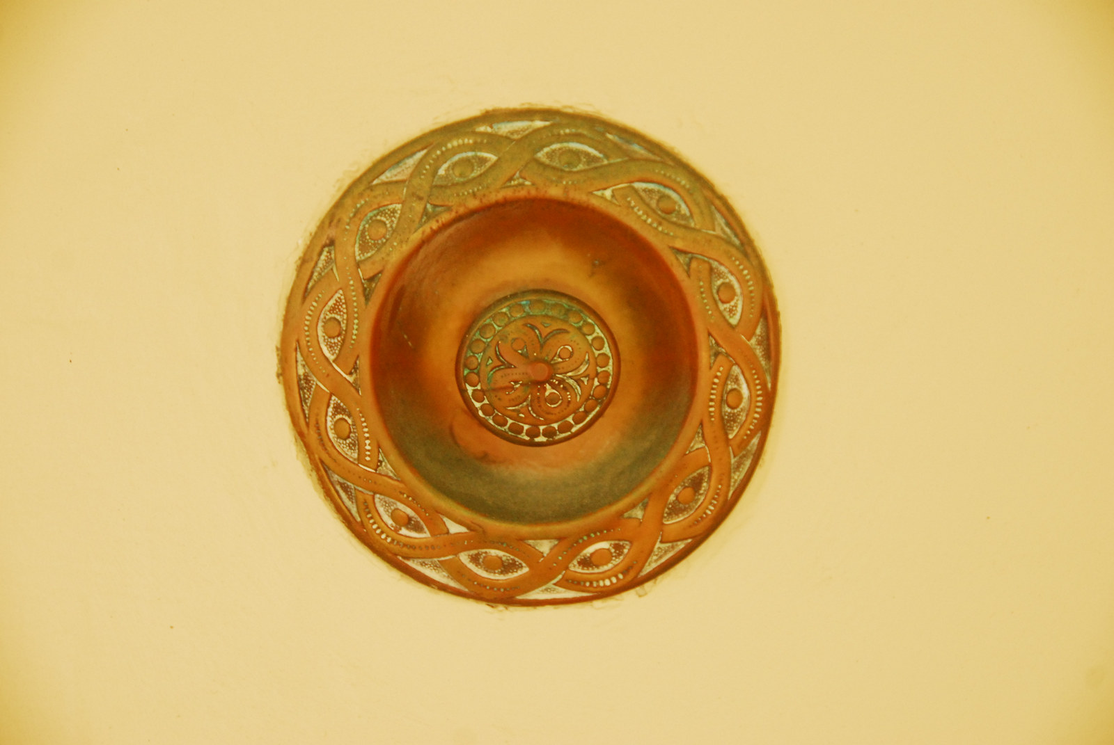 Closeup of ornately decorated doorbell.