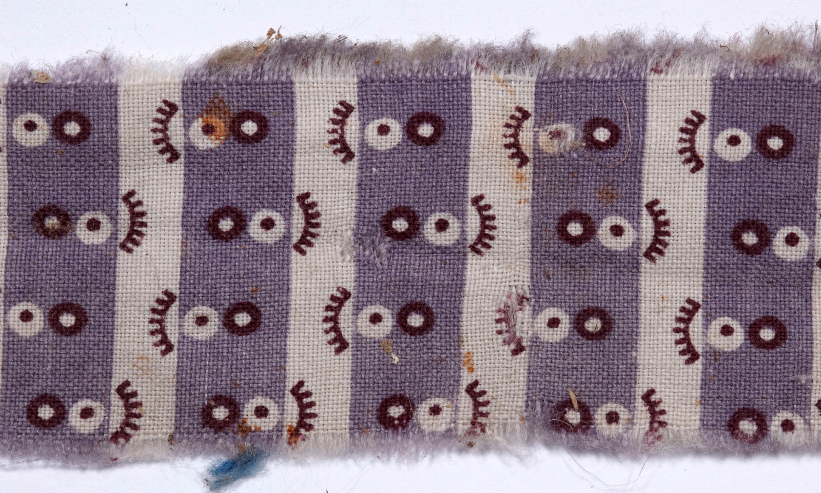 Fragment of purple patterned cloth.