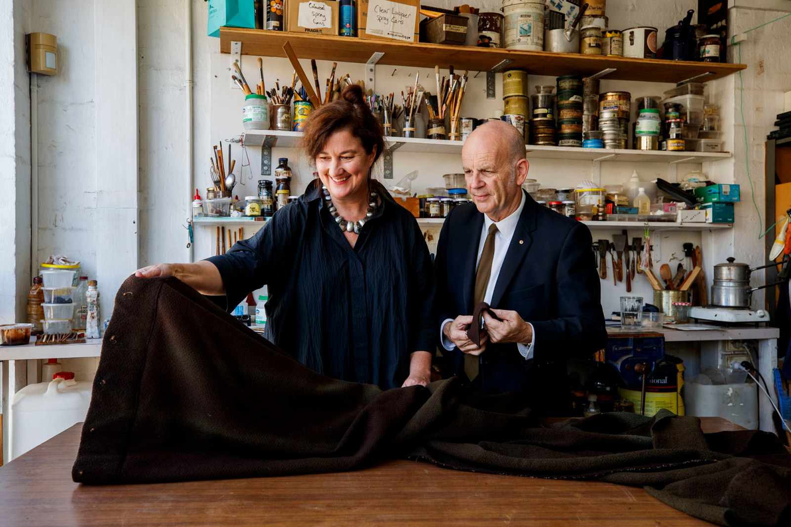 Curator Joanna Nicholas and Brian Seidler (son of Marcus Seidler) discussing the reupholstery of the Rose Seidler House couch on the premises of Ben Stoner Antiques Conservation & Restoration. 