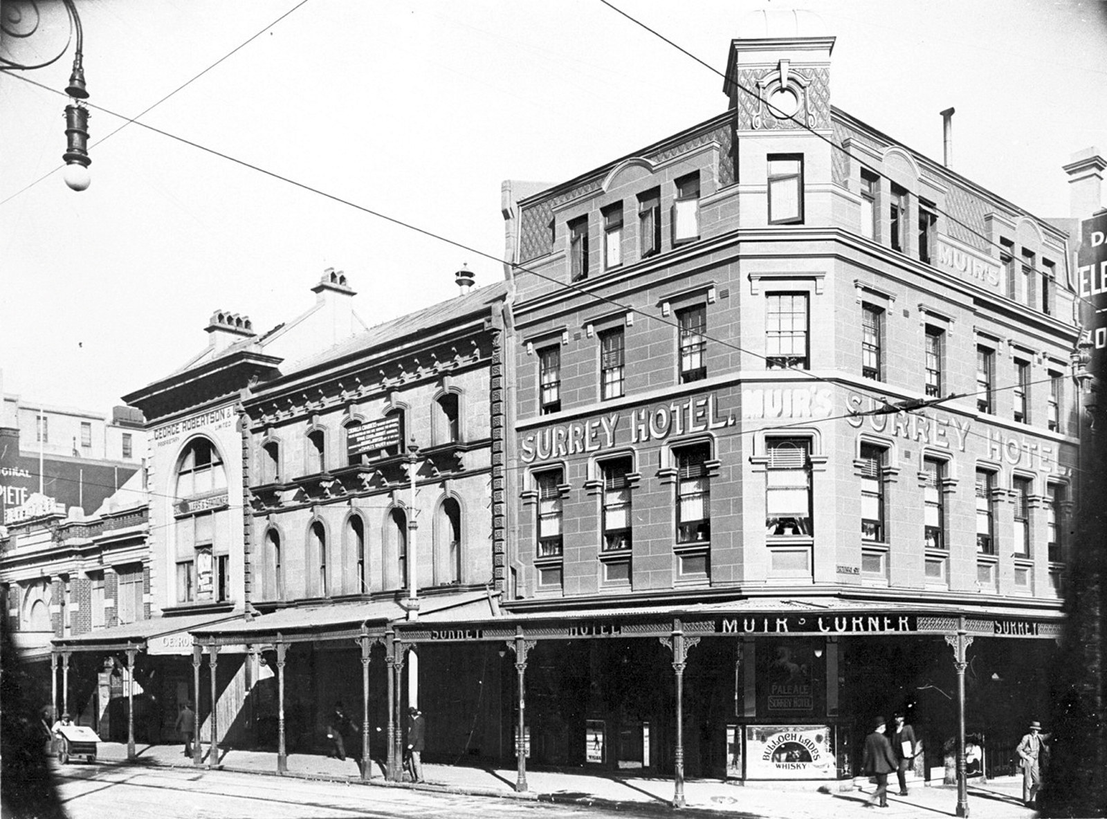 Exterior image of street showing four storey Victorian style building on a corner.