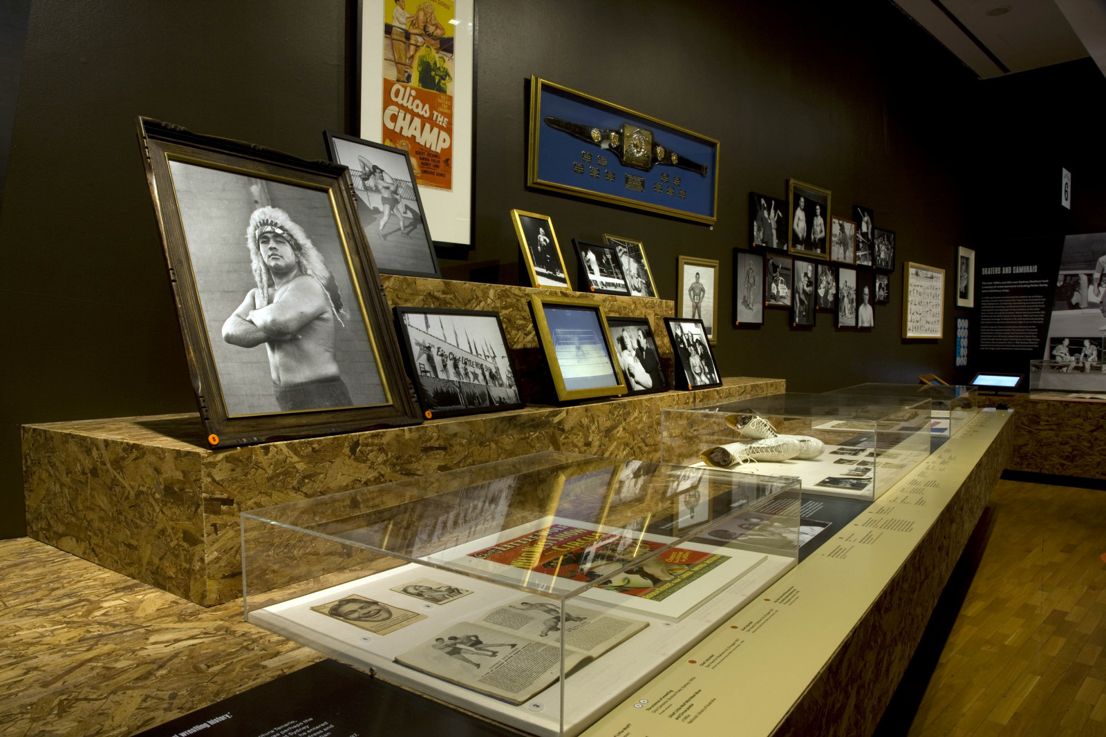 Installation view showing display case with photos and papers.