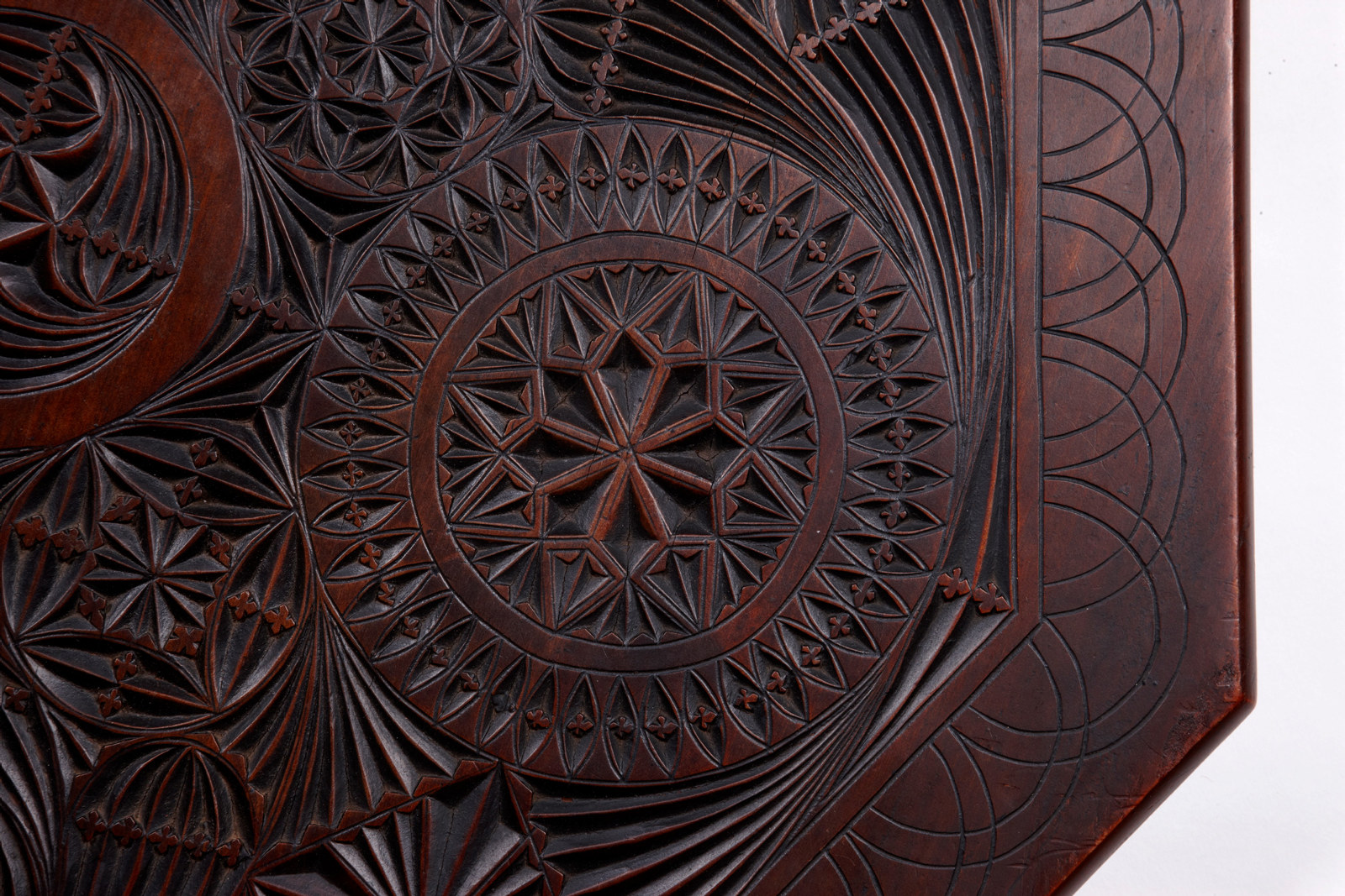 Detail of top of demountable, chip-carved occasional table made by carpenter George Stevenson Liggins