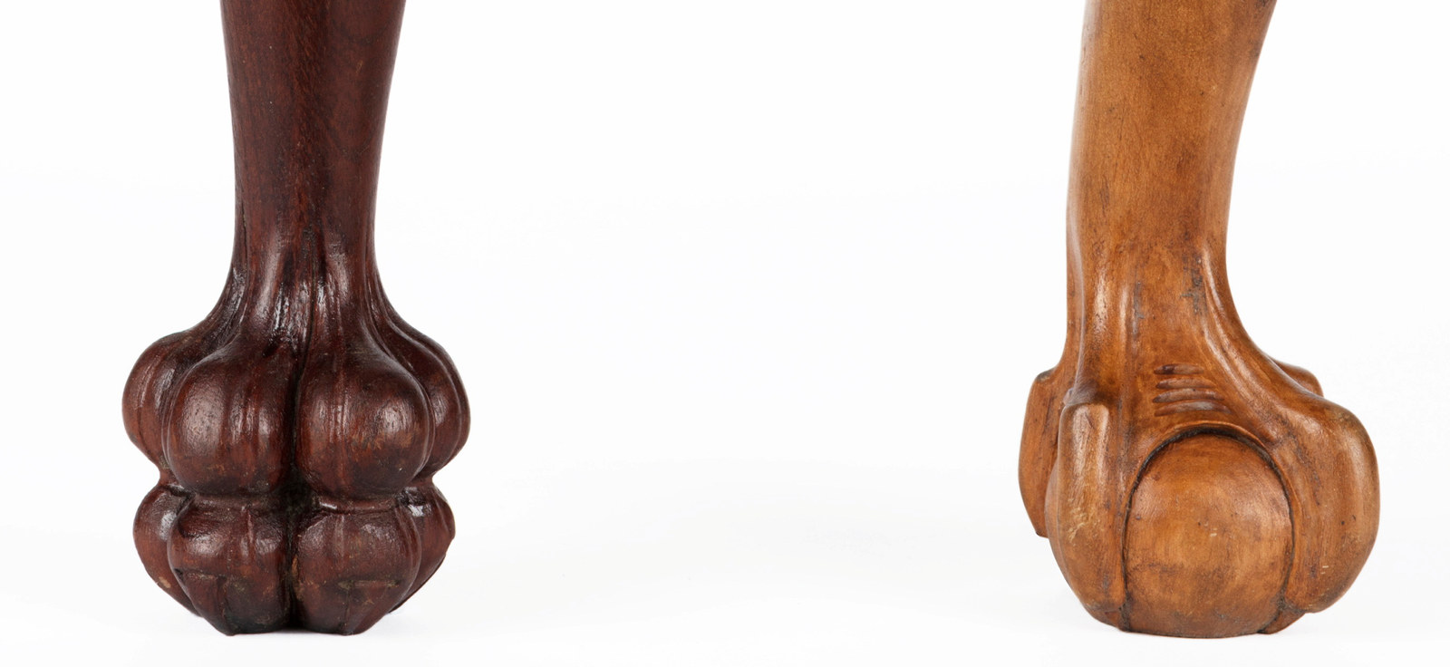 Two carved timber furniture legs