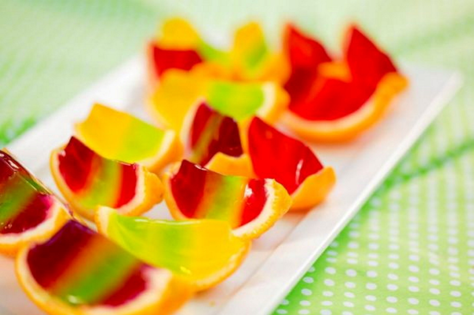 Sliced oranges filled with multicoloured layers of jelly.