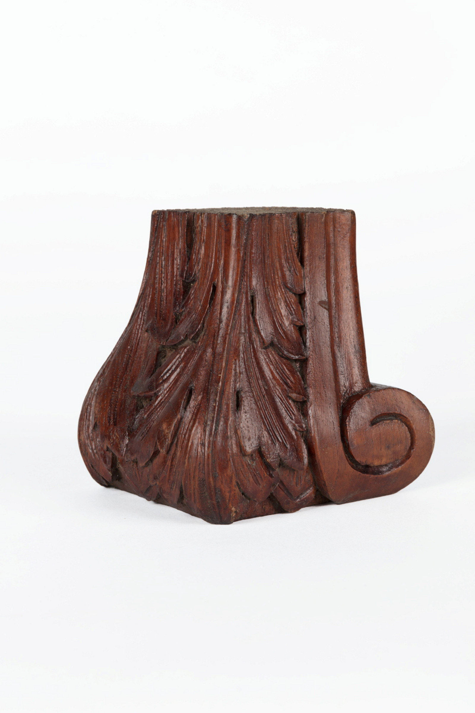 A carved timber furniture foot