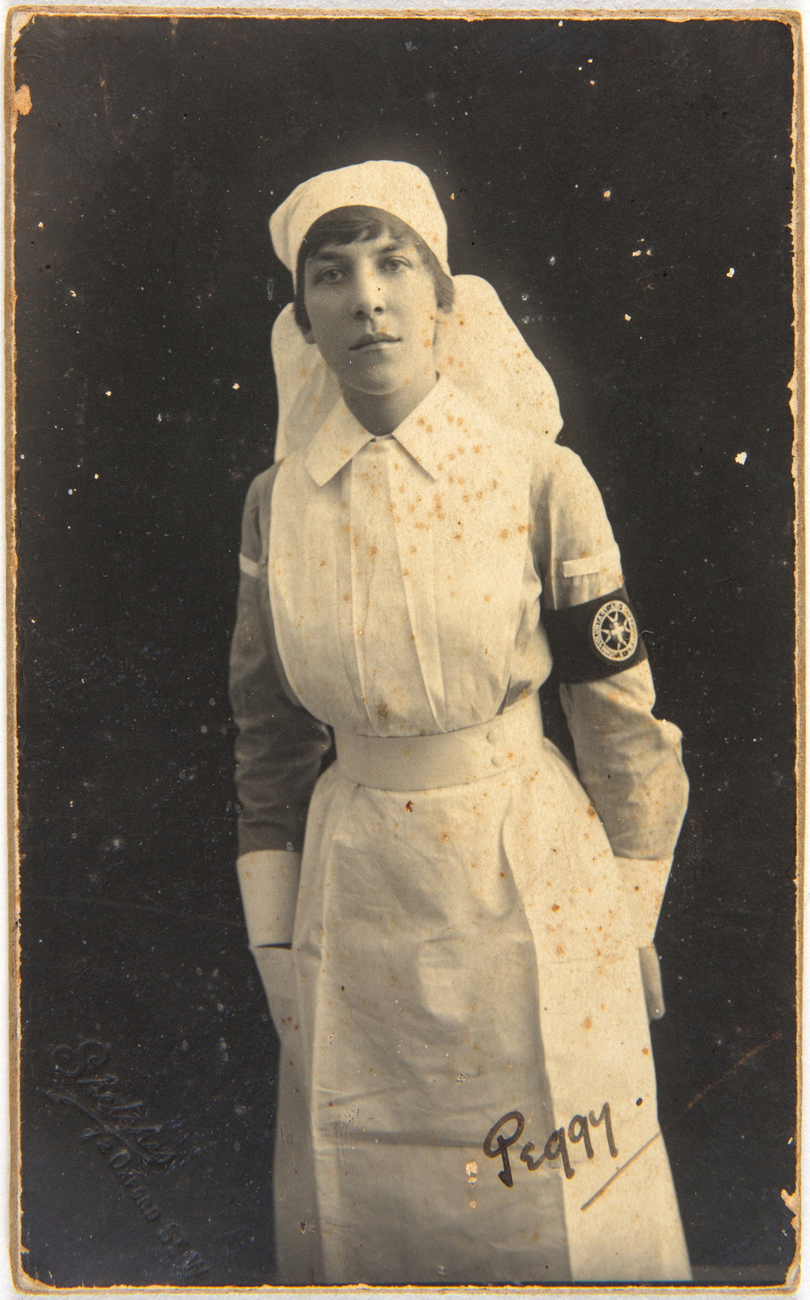 Mounted photograph of Peggy Manning in St John VAD uniform during World War I, Sketches, London, c1917