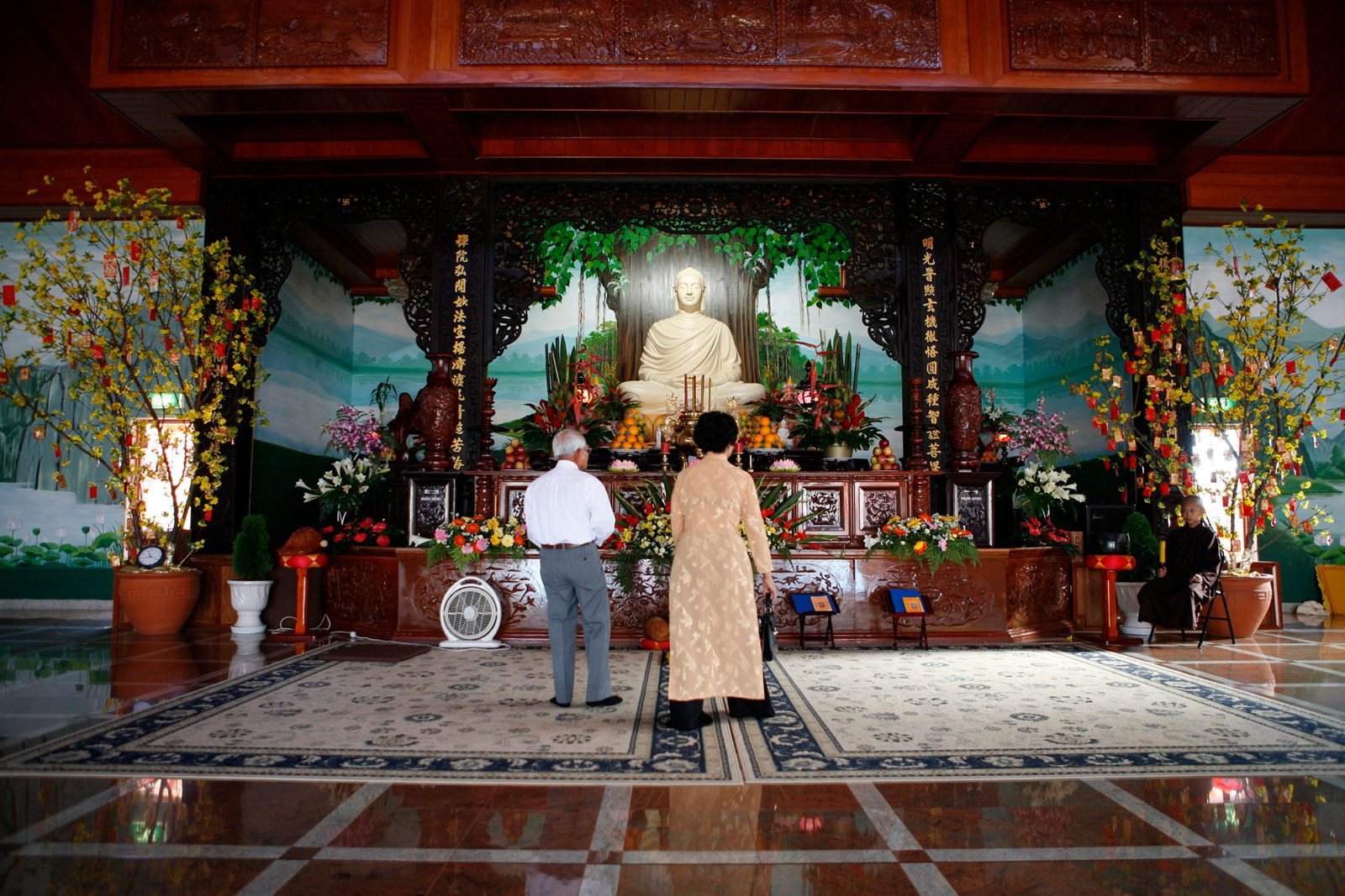 Thi Tam Nguyen and Cao Nam Le pray at Thien Vien Minh Quang, Canley Vale - Rituals and Traditions of Sydney.