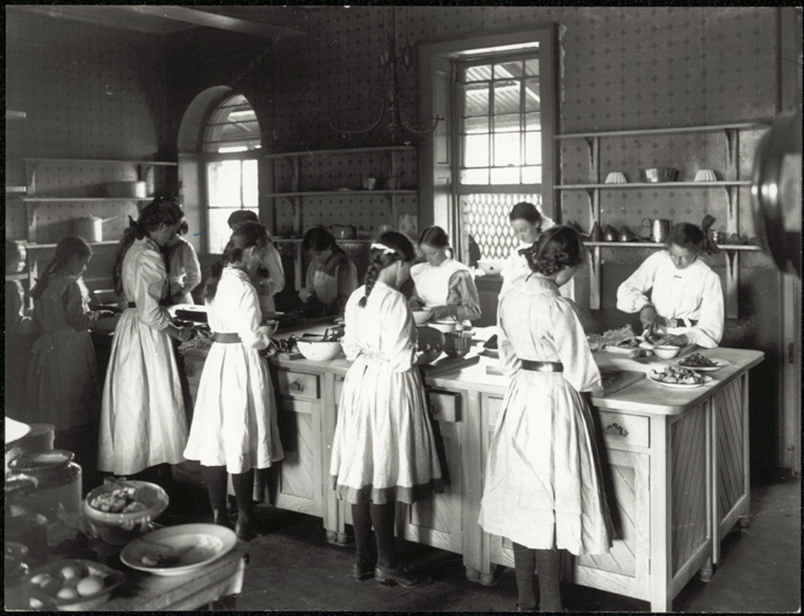 Black and white image of girls cooking.