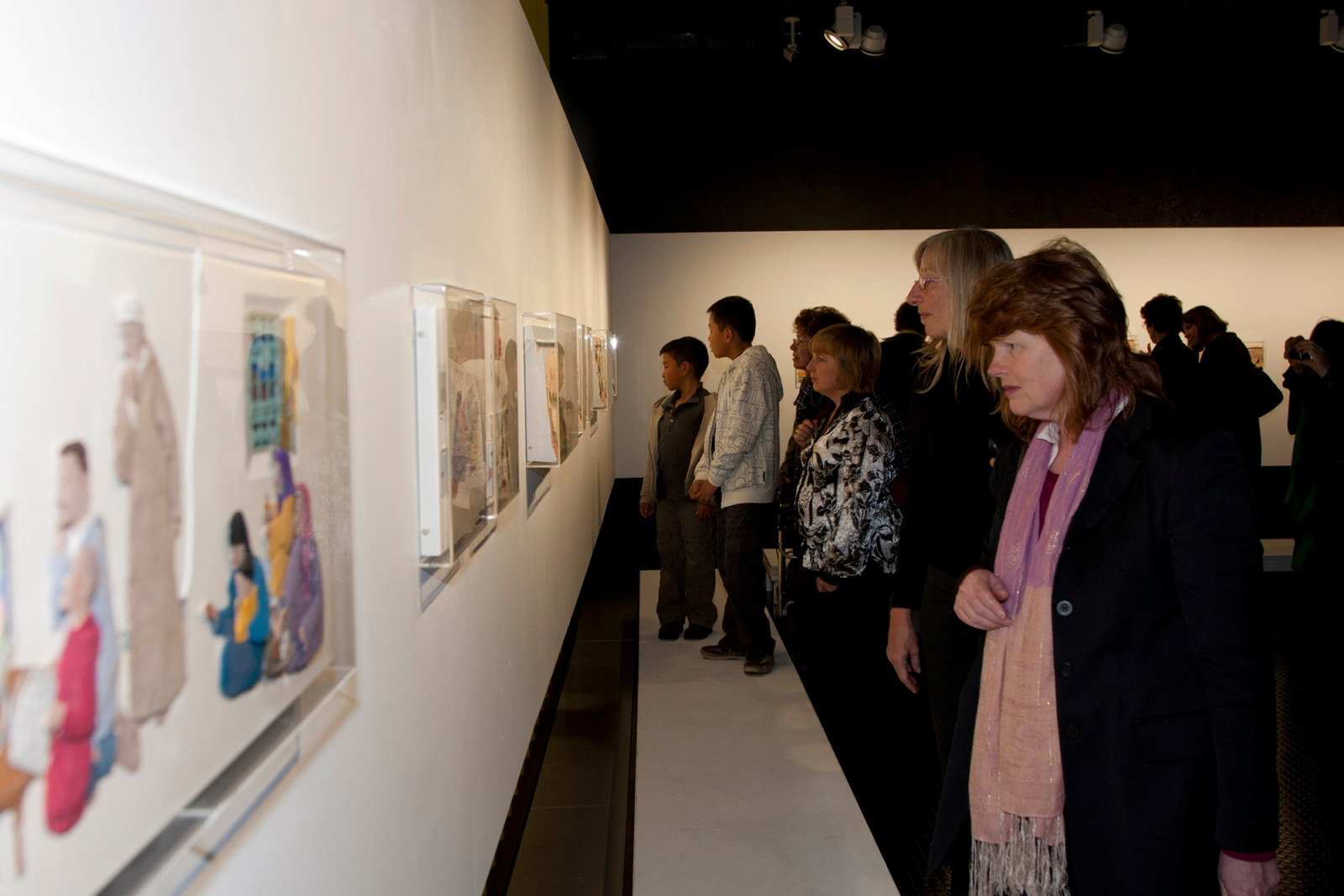 Guests looking at artworks in Theme Gallery exhibition space