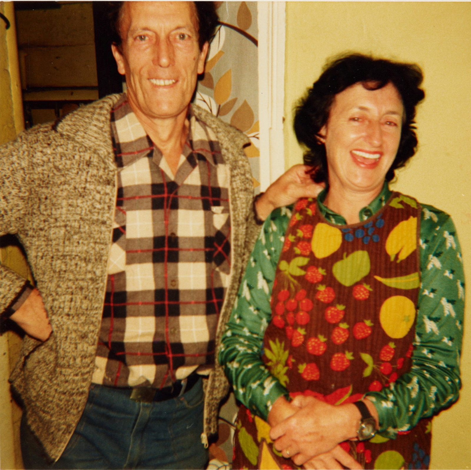 Man wearing cardigan and checked shirt (left) with woman wearing colourful top (right).
