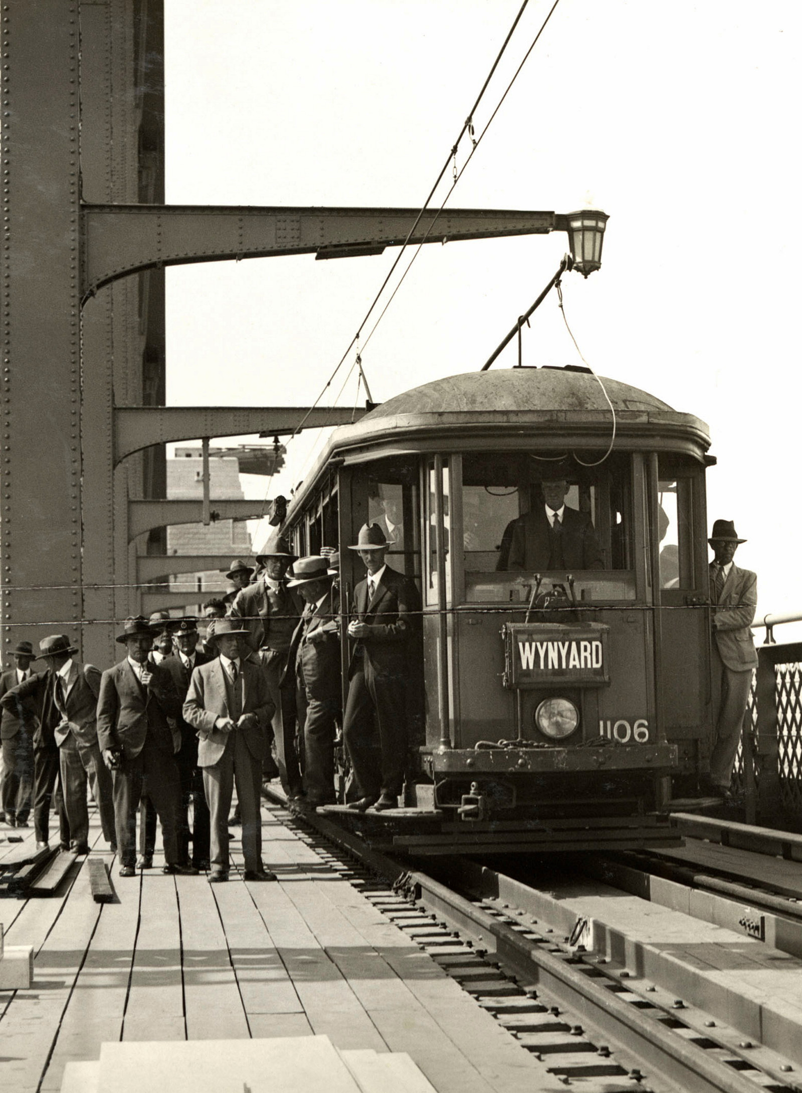 People file onto a tram waiting on the outside lane of the Harbour Bridge