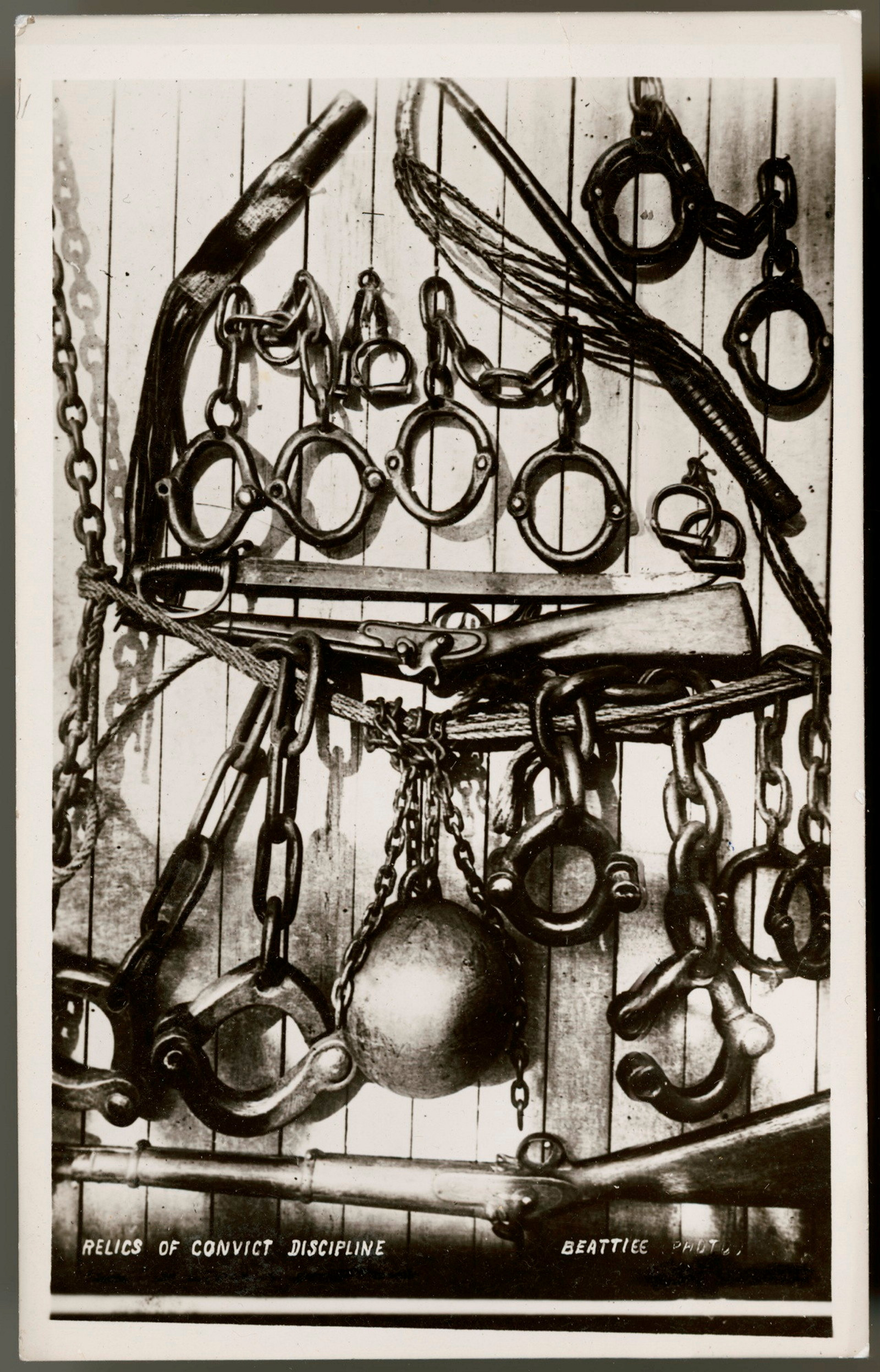 Black and white printed postcard depicting convict discipline tools.