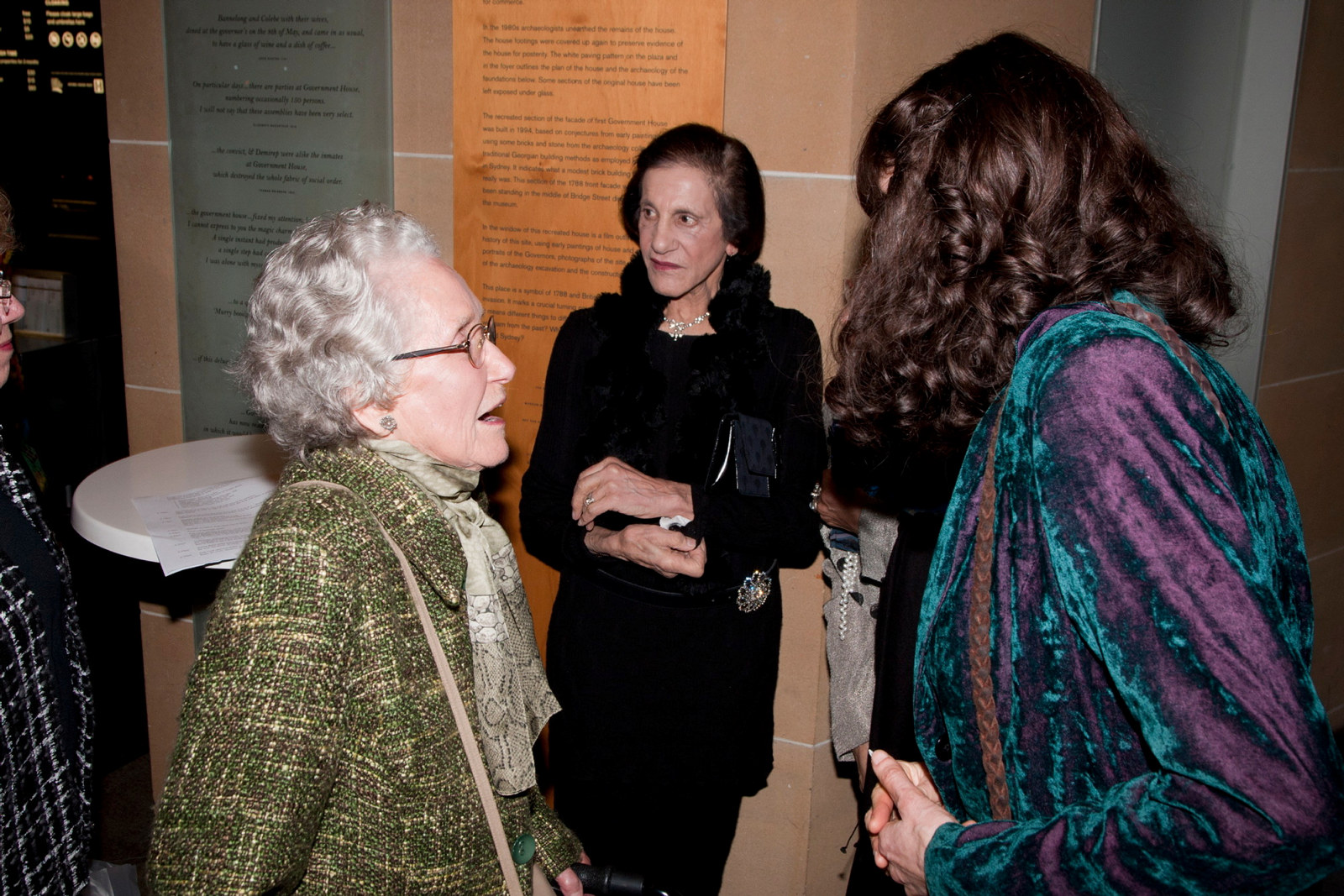 Jeannie Baker speaks with guest during opening