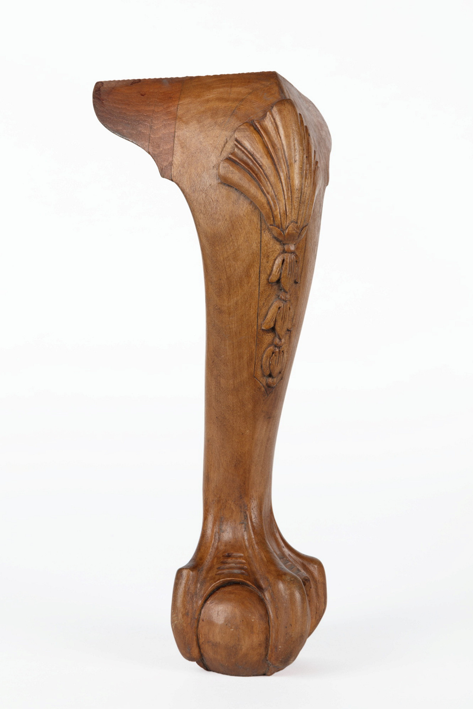 A carved timber furniture leg
