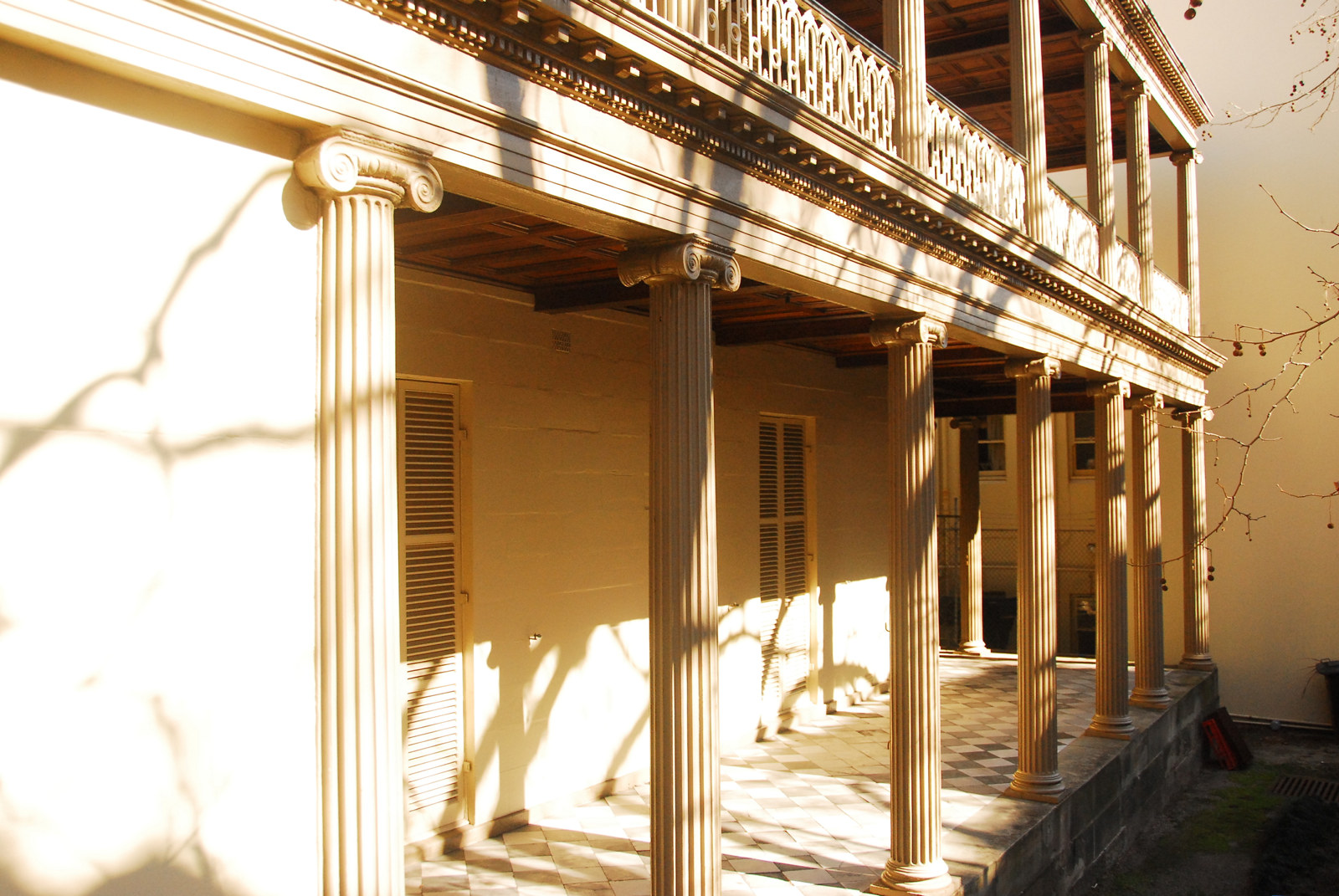 View of sunlit verandah and supporting columns.