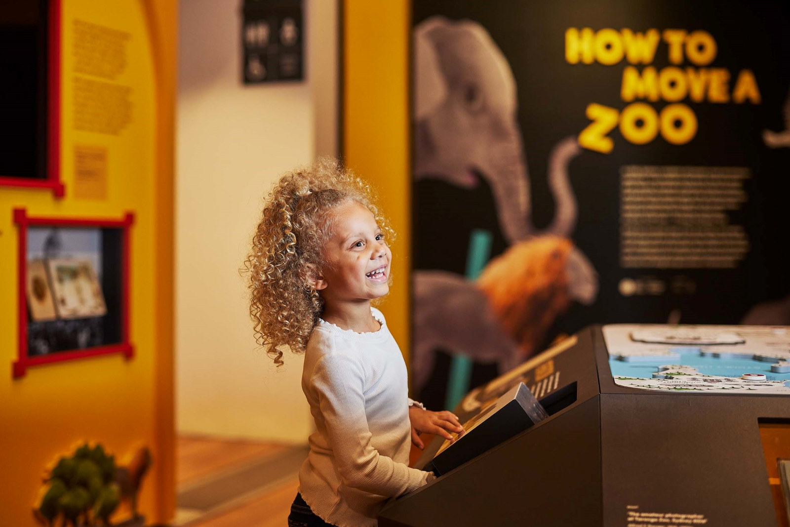 Child exploring the How to Move a Zoo exhibition.