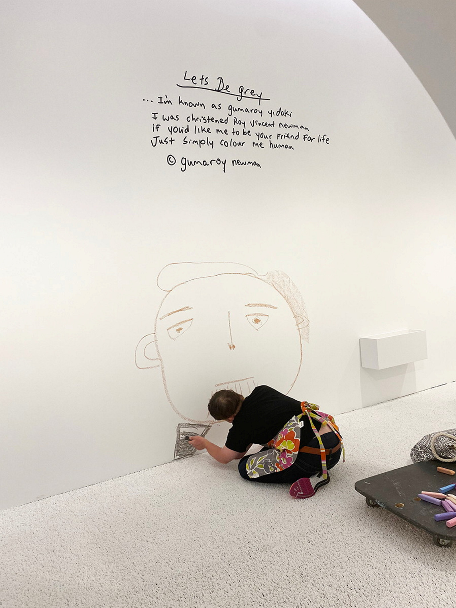 Digby Webster drawing on the wall during Make Your Mark exhibition