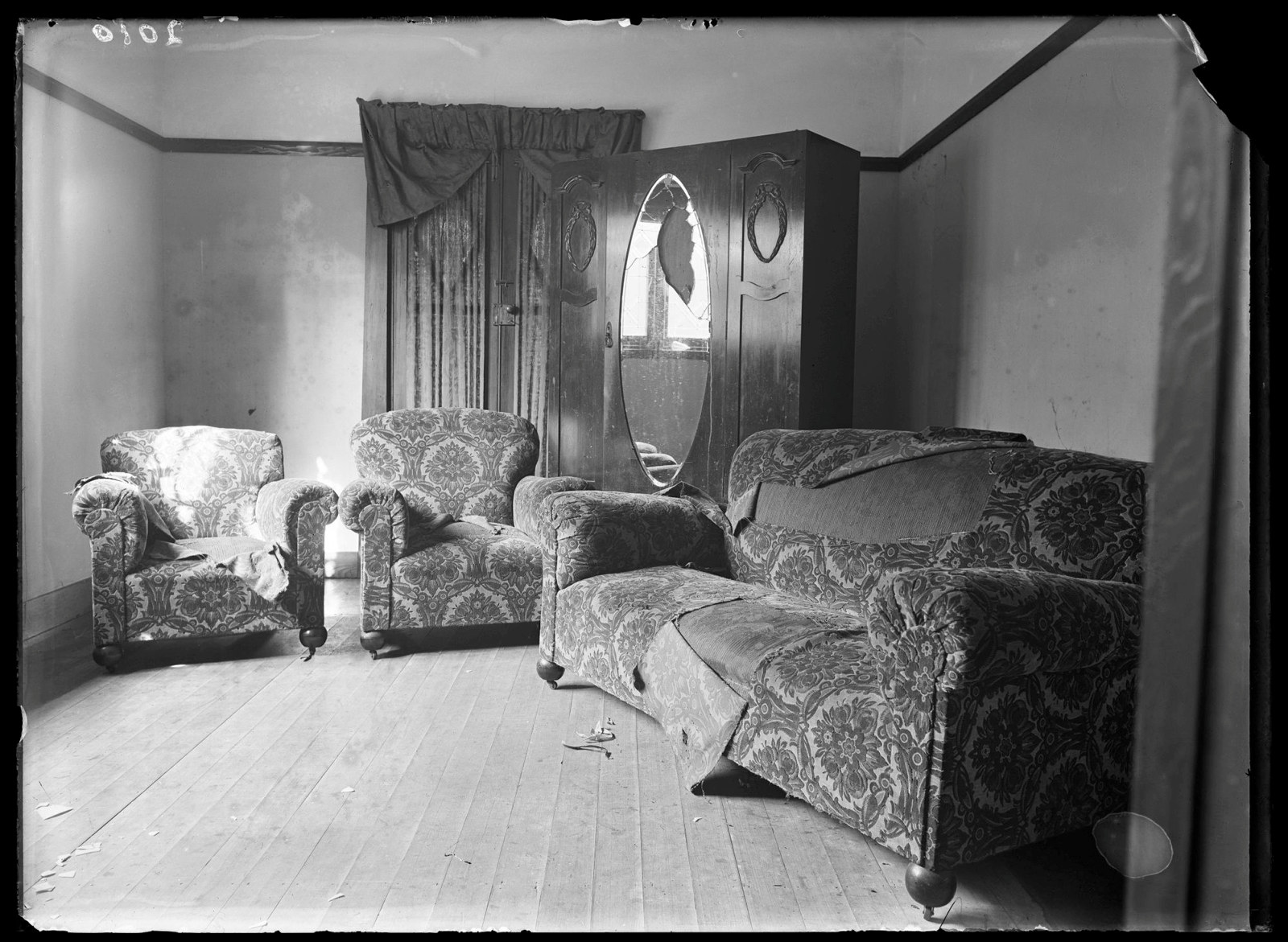 Living room interior with vandalised lounges and smashed wardrobe mirror, location unknown, Sydney, c1934