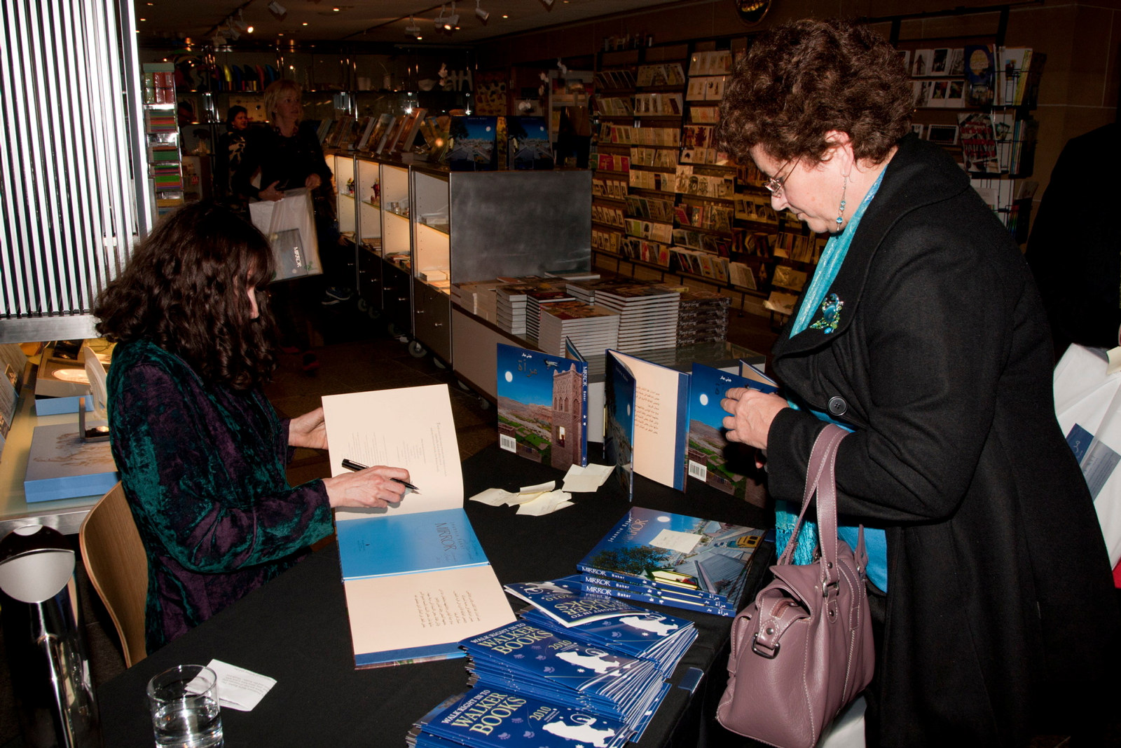 Jeannie Baker signing copies of book for guest