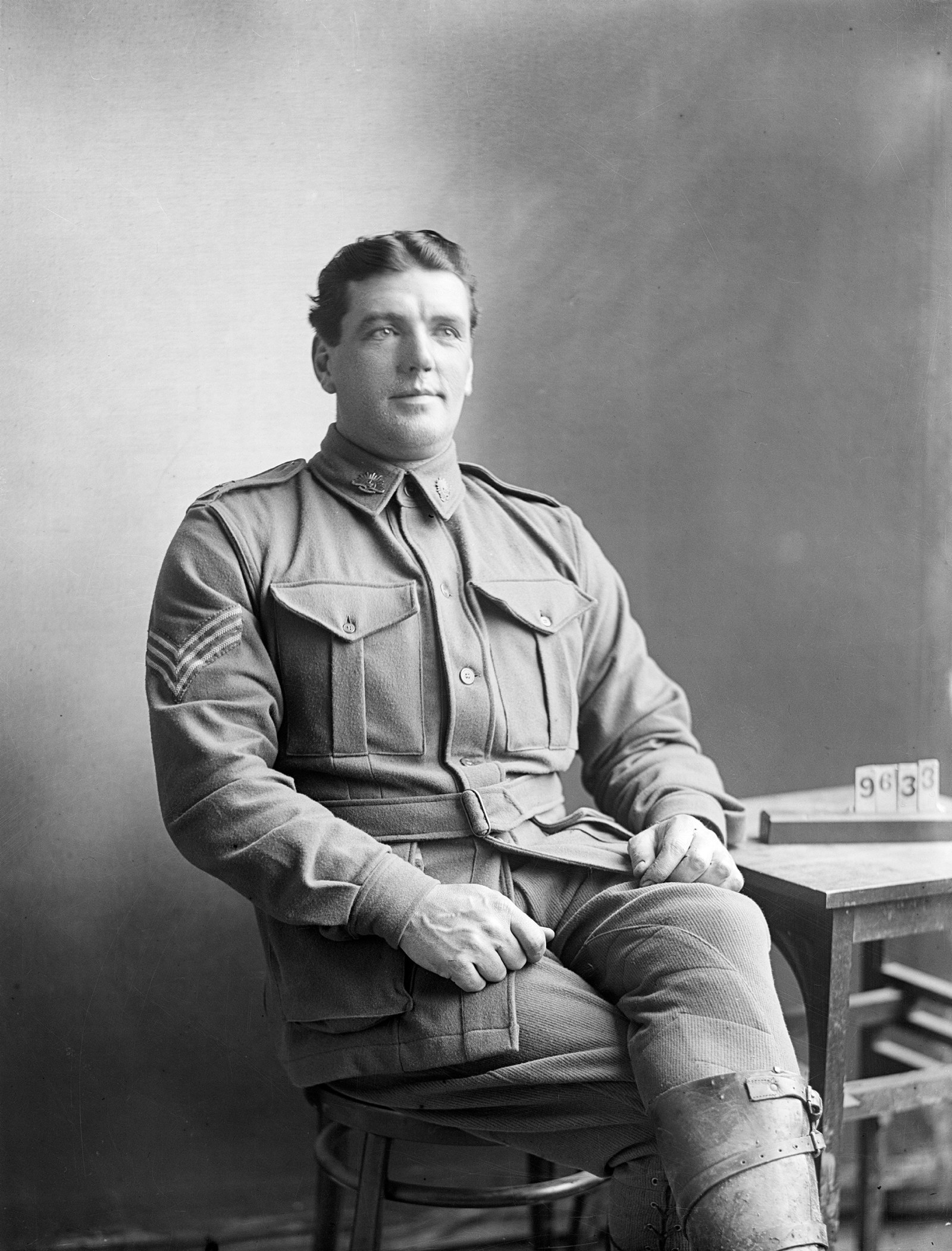 Black and white illustration of a seated man in uniform.