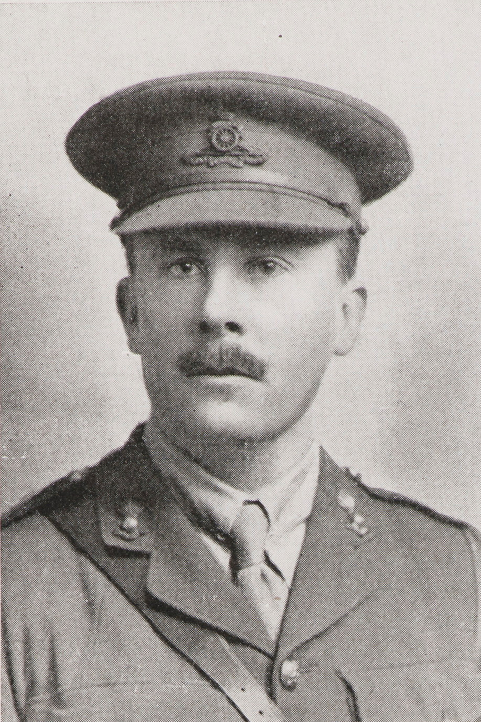 Black and white portrait of man in uniform with moustache.