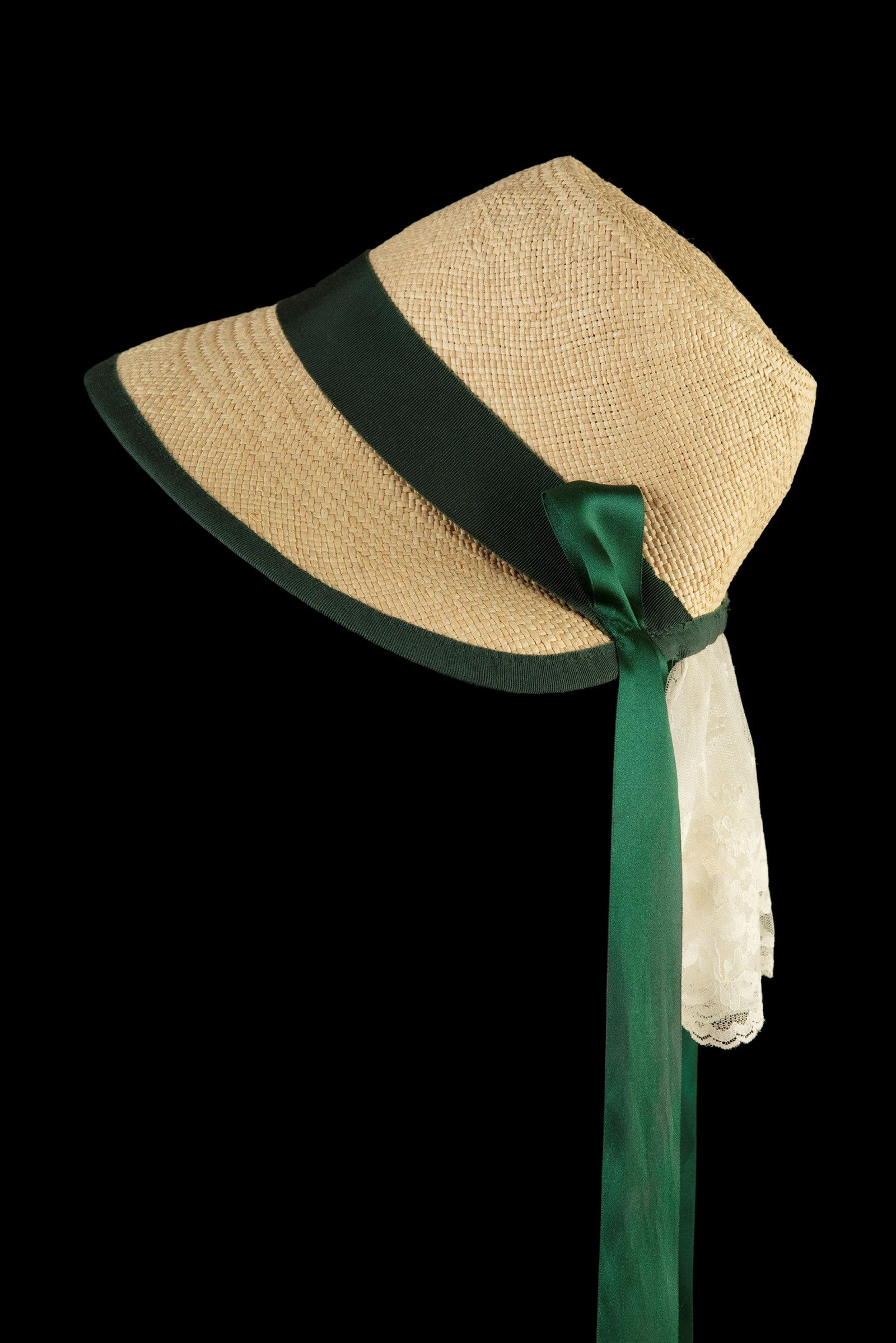 Reproduction of a mid nineteenth century cottage bonnet with green ribbon.