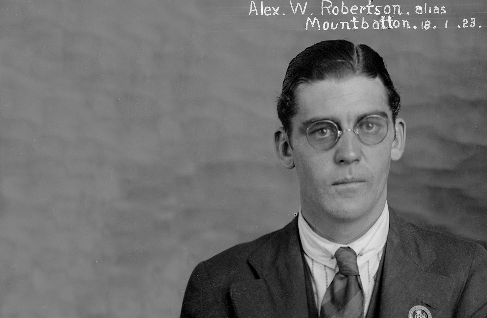 Black and white photograph of a man wearing glasses. Words Alex W. Robertson, Mountbatton  18.1.23 are written by hand on the image