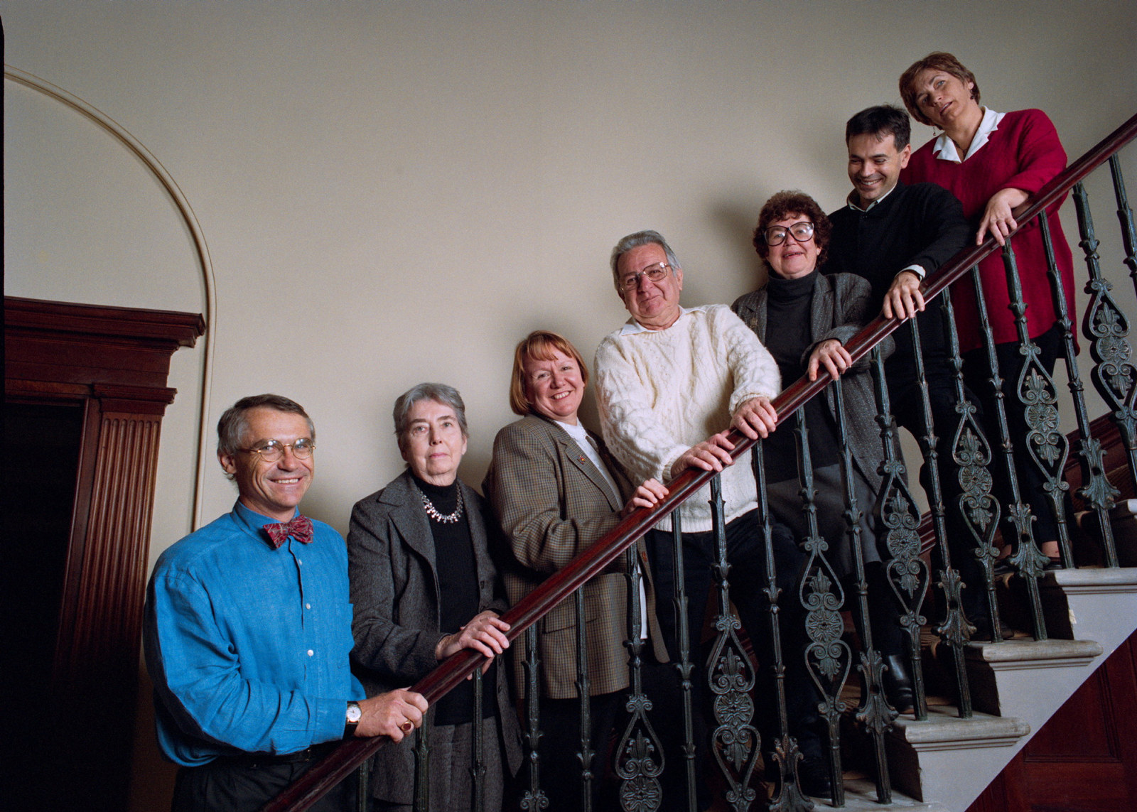 Group of people standing on staircase. Jack is in white shirt in centre of image.