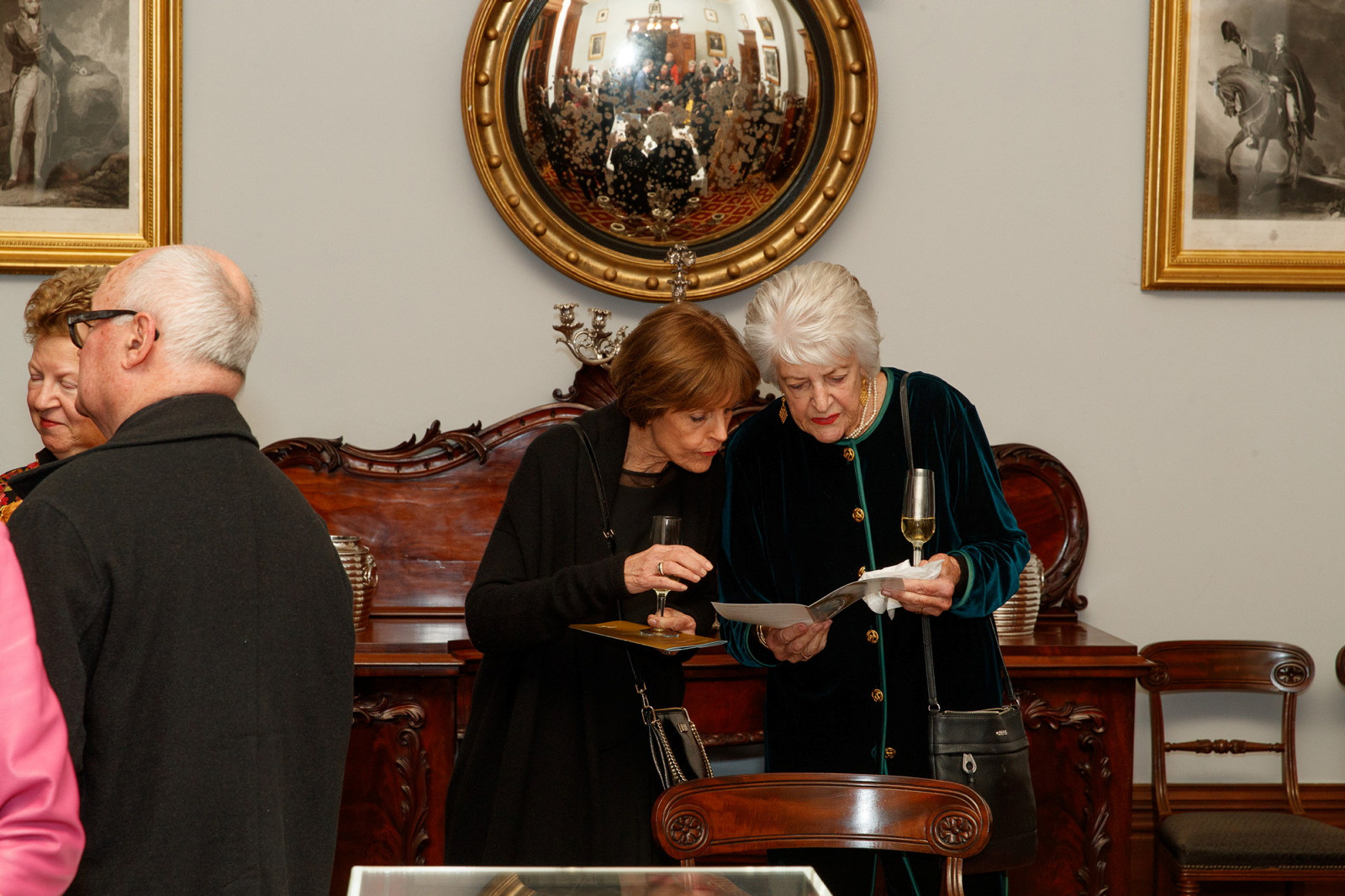 Margot Chinneck and Jennifer Fisher examine the program at the Bel Canto in the Bush recital