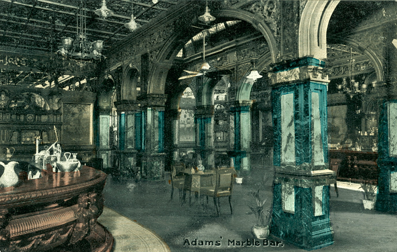 Hand coloured photograph showing the elaborate stonework and panelling of the bar interior.