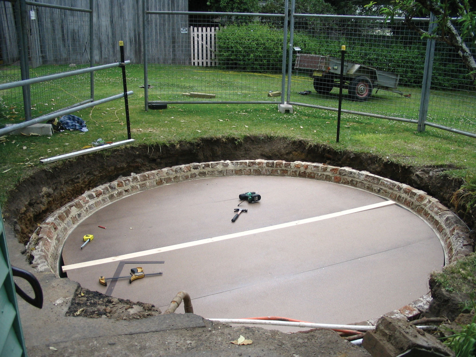 Underground brick water tank or cistern with domed roof being demolished and reconstructed.