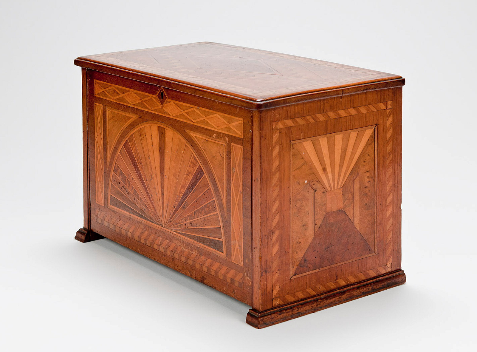 Wooden chest with inlaid pattern.