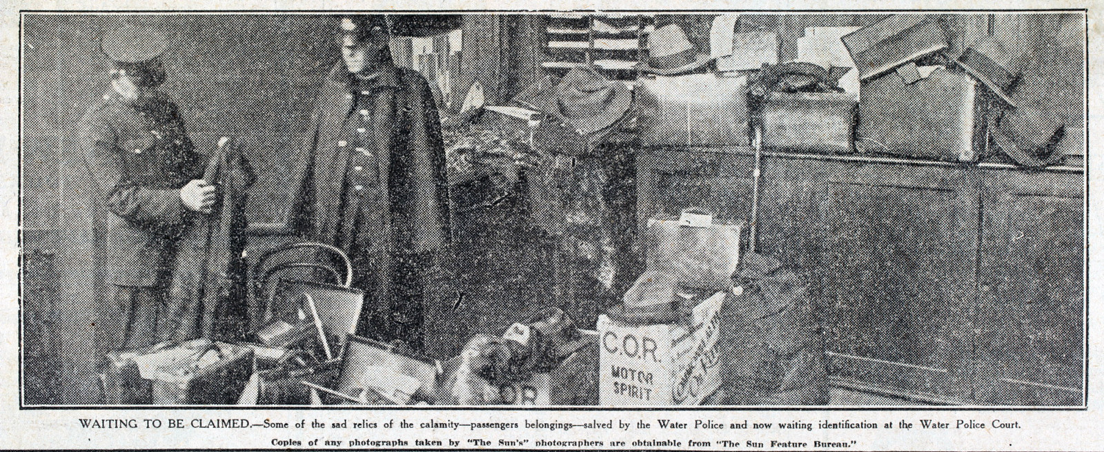 Newspaper clipping of photograph of police with belongings.