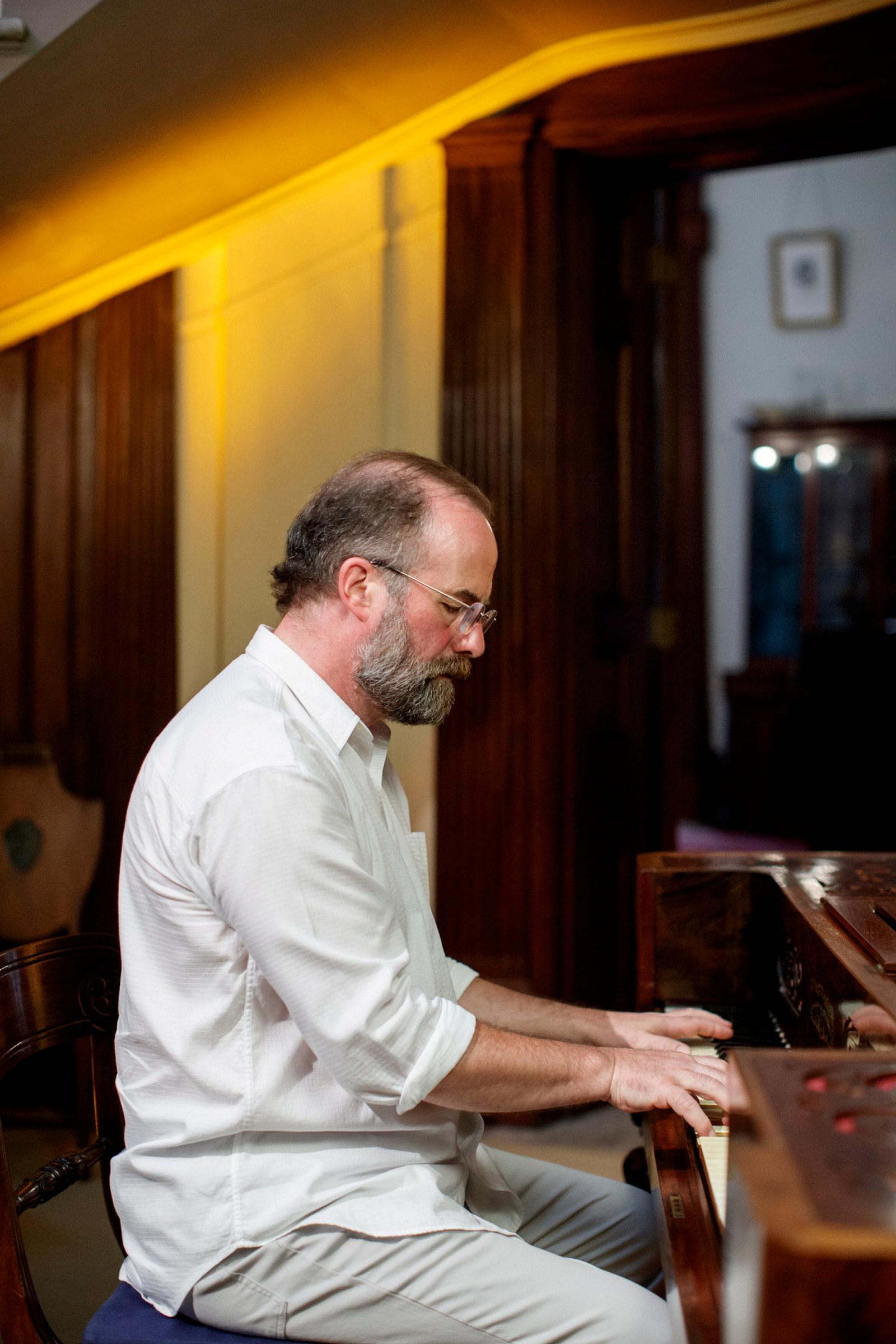 Ian Blake, composer and performer, playing piano in the saloon at Elizabeth Bay House