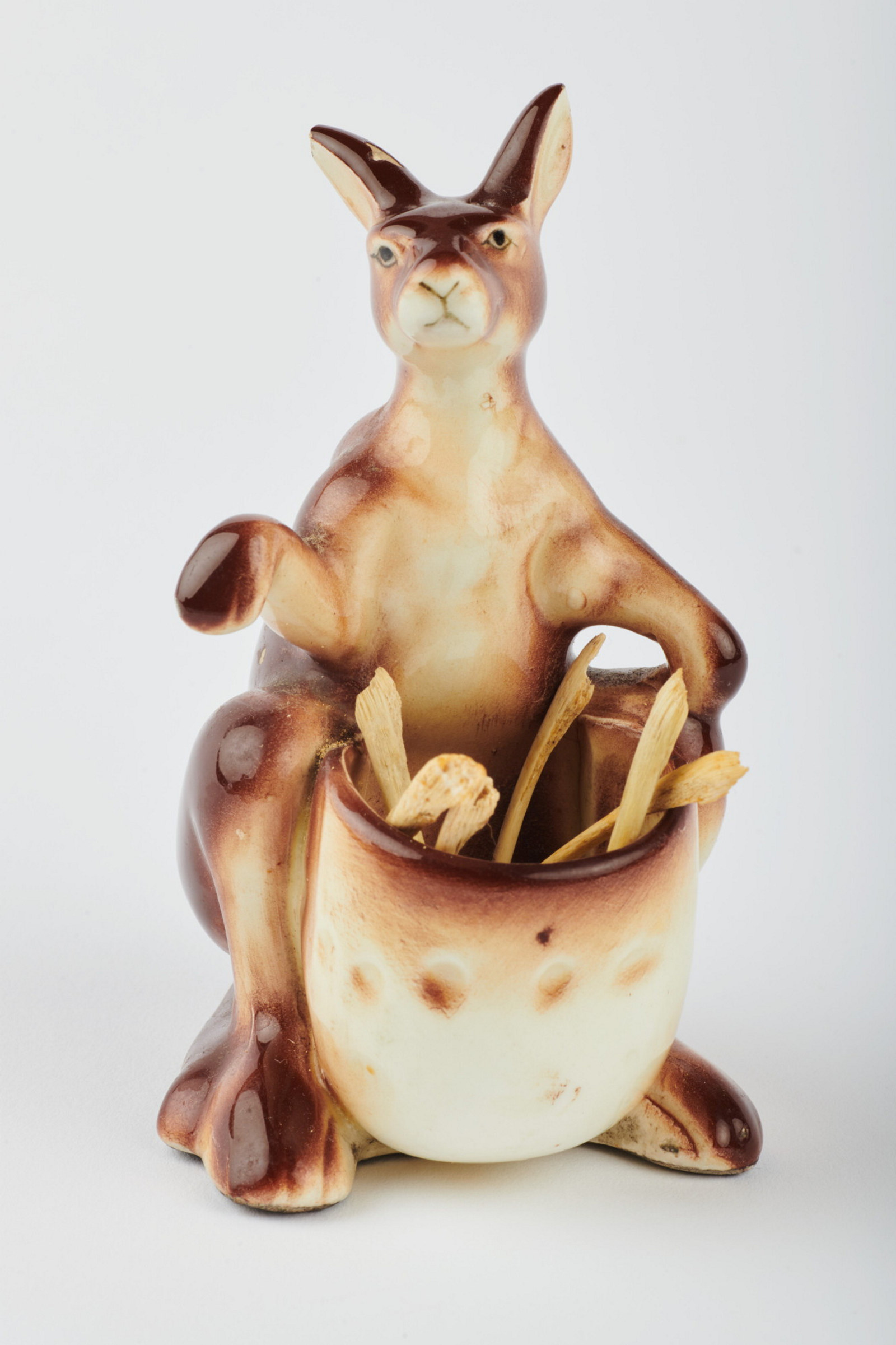 Brown and white ceramic kangaroo with bones.