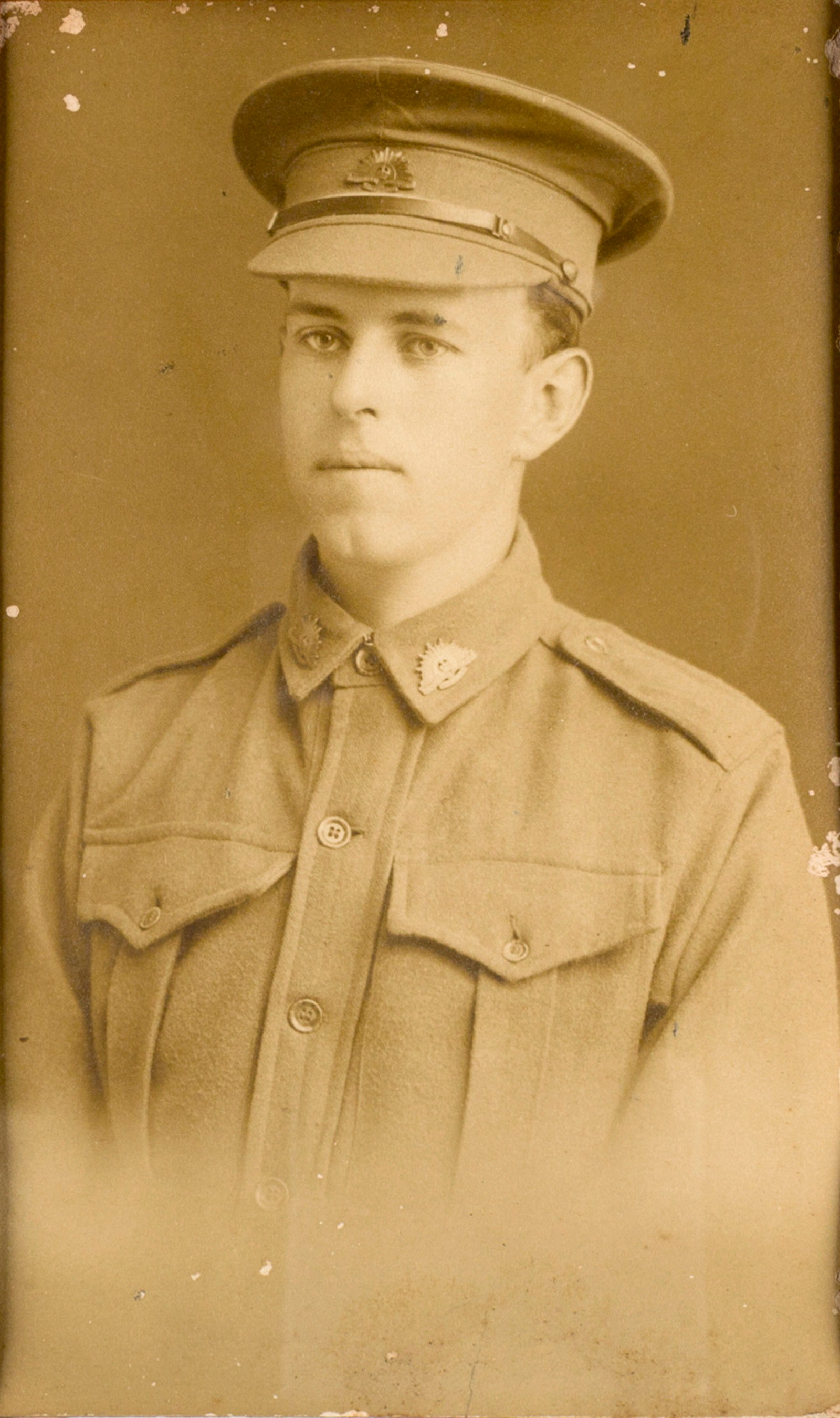 Sepia toned black and white photo of man in uniform.