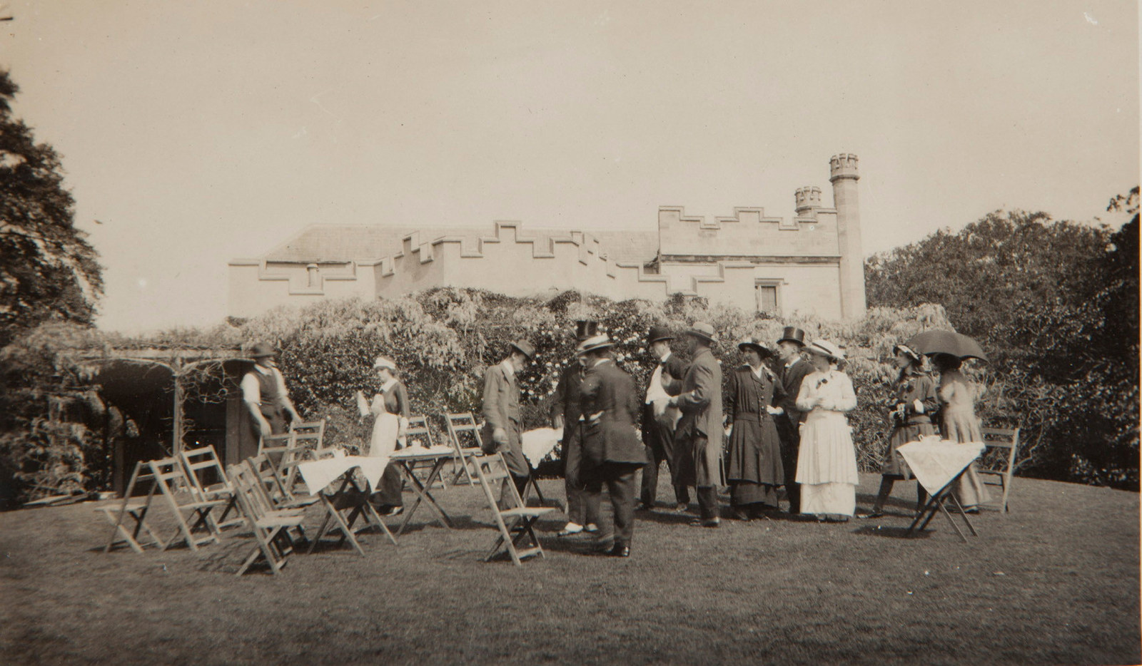 Tea party in front of wisteria: photograph taken at Vaucluse House around 1912, from 'Nielsen-Vaucluse Park Trust' photograph album, no.2.