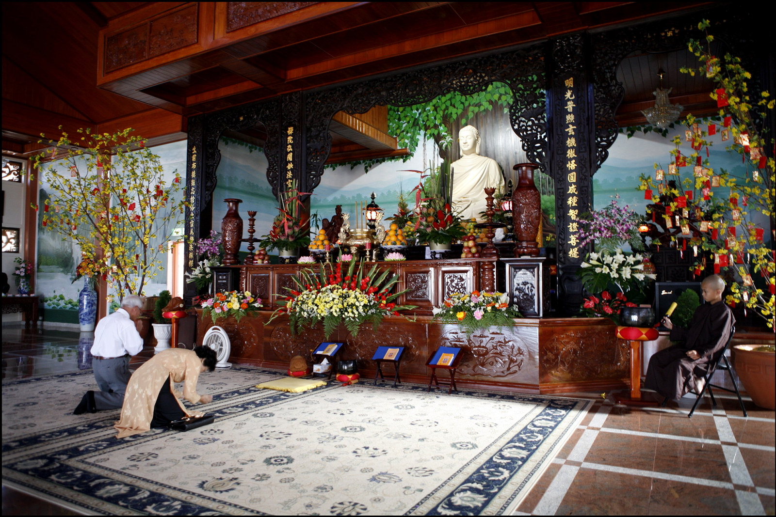 Thi Tam Nguyen and Cao Nam Le pray at Thien Vien Minh Quang, Canley Vale -Rituals and Traditions of Sydney.